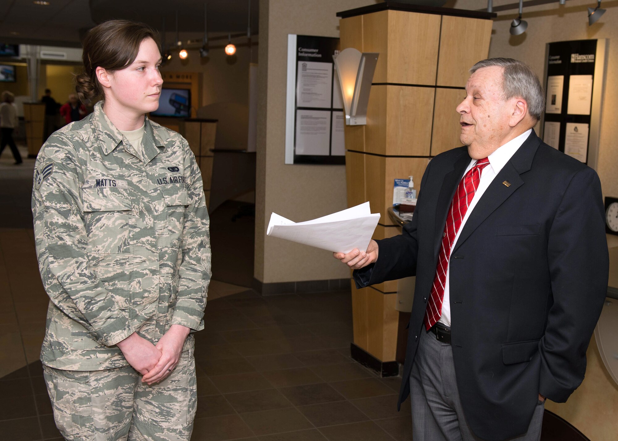 Paul Marotta, Hanscom Federal Credit Union chairman of the board, speaks to Senior Airman Kara Watts, Patriot Enlisted Association president, at the credit union March 30. The Armed Forces Financial Network provided $1,500 as a matching award to the PEA professional organization following the Board of Director’s Memorial Award and $1,500 contribution last fall. (U.S. Air Force photo by Jerry Saslav)