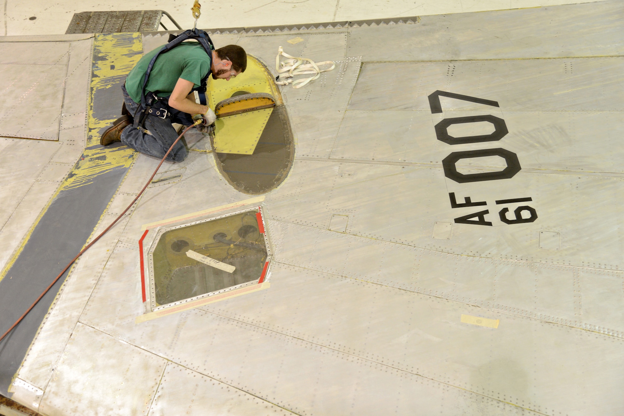 Jamin Alato, an aircraft mechanic with the 565th Aircraft Maintenance Squadron, replaces nut plates on “Ghost Rider’s” vertical stabilizer. The B-52 Stratofortress, tail number 61-007, is currently undergoing extensive programmed depot maintenance here at Tinker Air Force Base. (Air Force photo by Kelly White/Released)