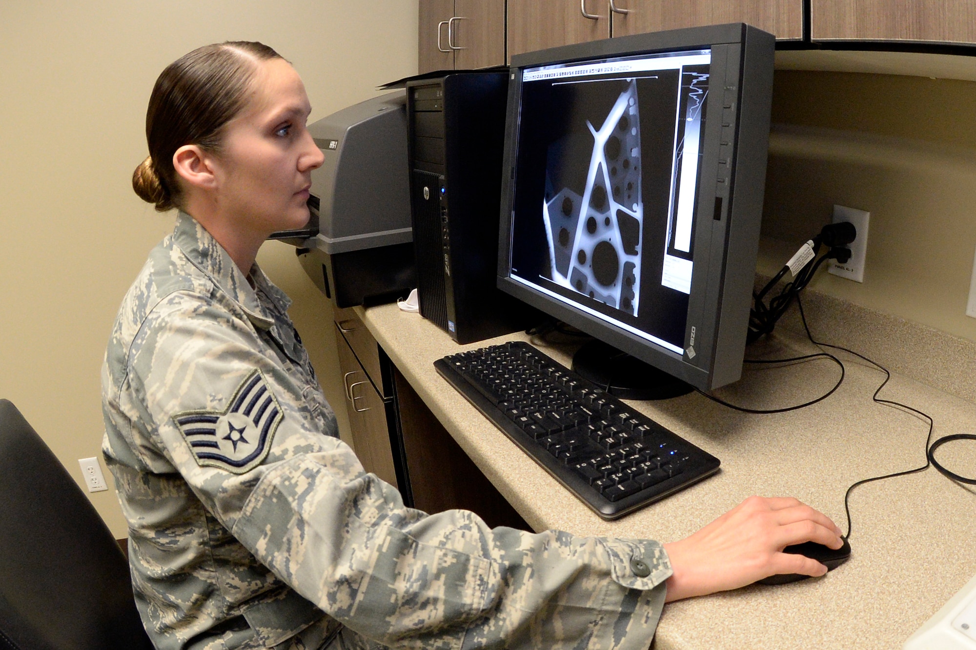 Staff Sgt. Cinnamon Kavlick, 388th Equipment Maintenance Squadron, inspects an X-ray image March 25 in the 388th EMS Non-Destructive Inspection laboratory at Hill Air Force Base, Utah. The 388th EMS NDI lab recently upgraded its radiography equipment with digital capabilities, improving the process of locating small cracks and identifying minute discontinuities in aircraft engines, wings, and other components. (U.S. Air Force photo by Todd Cromar) 