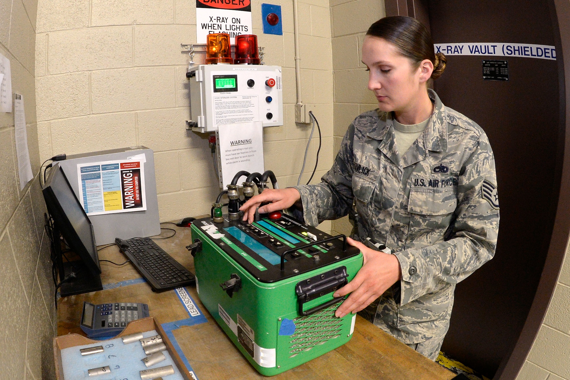 Staff Sgt. Cinnamon Kavlick, 388th Equipment Maintenance Squadron, adjusts the control box setting for a weld certification March 25 in the 388th EMS Nondestructive Inspection laboratory at Hill Air Force Base, Utah. The 388th EMS NDI lab recently converted its radiography equipment from a film-based to a digital output, which provides for excellent image sharpness, improving the probability of detecting flaws in aircraft engines, wings, and other components. (U.S. Air Force photo by Todd Cromar) 