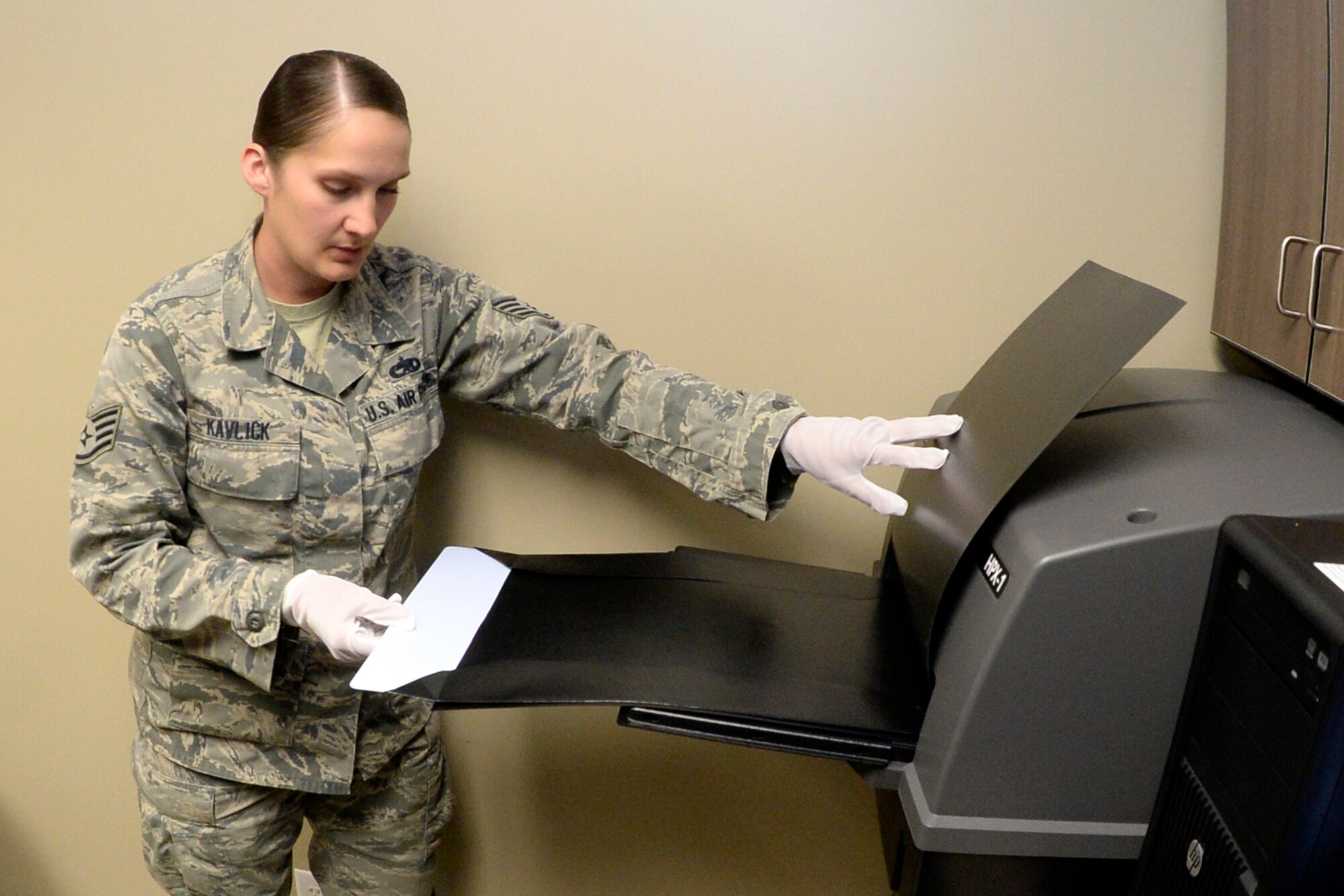 Staff Sgt. Cinnamon Kavlick, 388th Equipment Maintenance Squadron, inserts a digital imaging plate to be scanned March 25 in the 388th EMS Non-Destructive Inspection laboratory at Hill Air Force Base, Utah. The 388th EMS NDI lab recently upgraded its radiography equipment with digital capabilities, improving the process of locating small cracks and identifying minute discontinuities in aircraft engines, wings, and other components. (U.S. Air Force photo by Todd Cromar) 