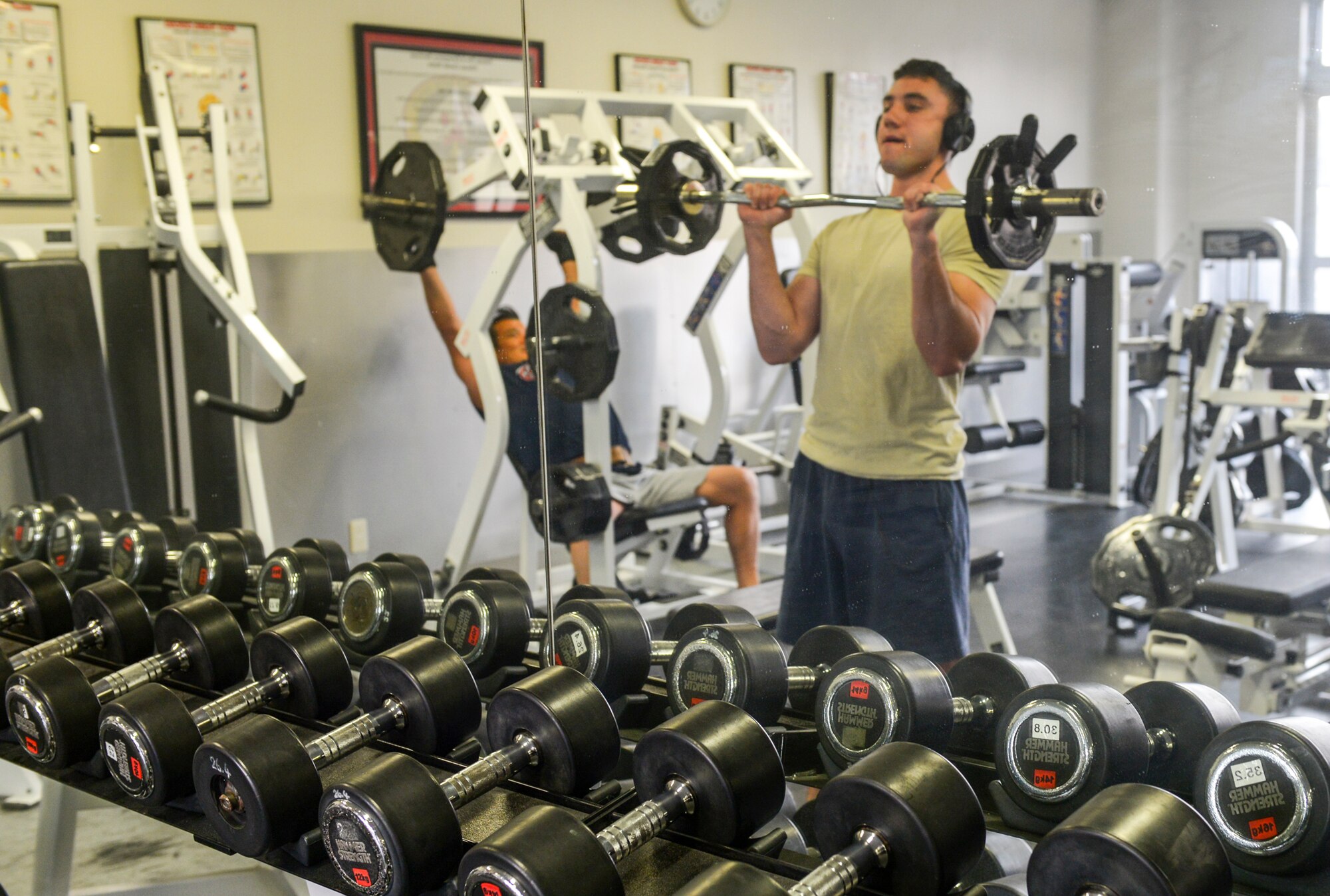 Senior Airman Stephen Taylor, 374th Civil Engineer Squadron fire and emergency services flight driver operator, exercises at Yokota Air Base, Japan, March 28, 2016. The 374 CES FEF personnel have bedrooms, showers, a gym and a kitchen available during 24-hour shifts at the fire department building, minimizing their need to leave the building and maximizing their ability to access emergency response equipment. (U.S. Air Force photo by Airman 1st Class Elizabeth Baker/Released)