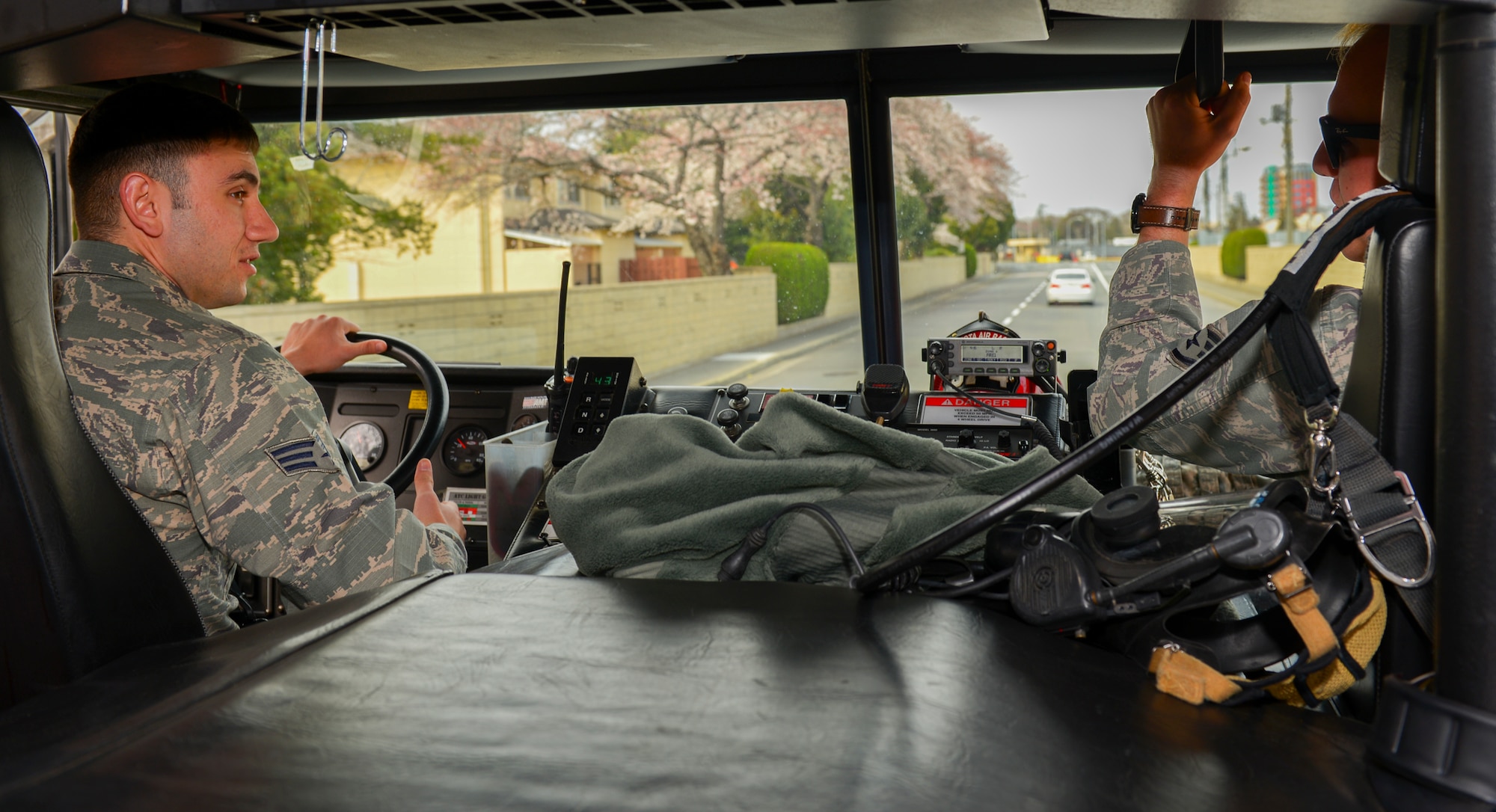 Senior Airman Stephen Taylor, 374th Civil Engineer Squadron fire and emergency services flight driver operator, drives a fire truck with Staff Sgt. Kyle Wirth, 374 CES FEF crew chief, at Yokota Air Base, Japan, March 28, 2016. The 374 CES FEF responds to a number of contingencies, including fire, injury and aircraft malfunction. (U.S. Air Force photo by Airman 1st Class Elizabeth Baker/Released)