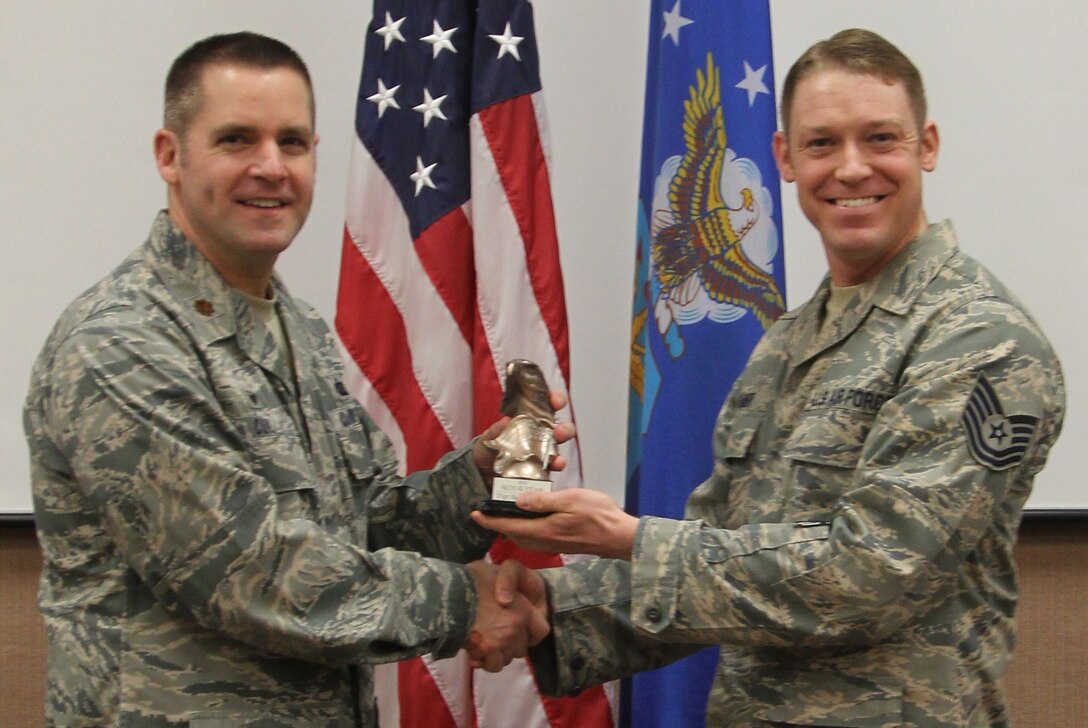 Major Coil presenting TSgt Shane Spanier with the 2015 Band of Flight Annual Noncommissioned officer Award. Congratulations!