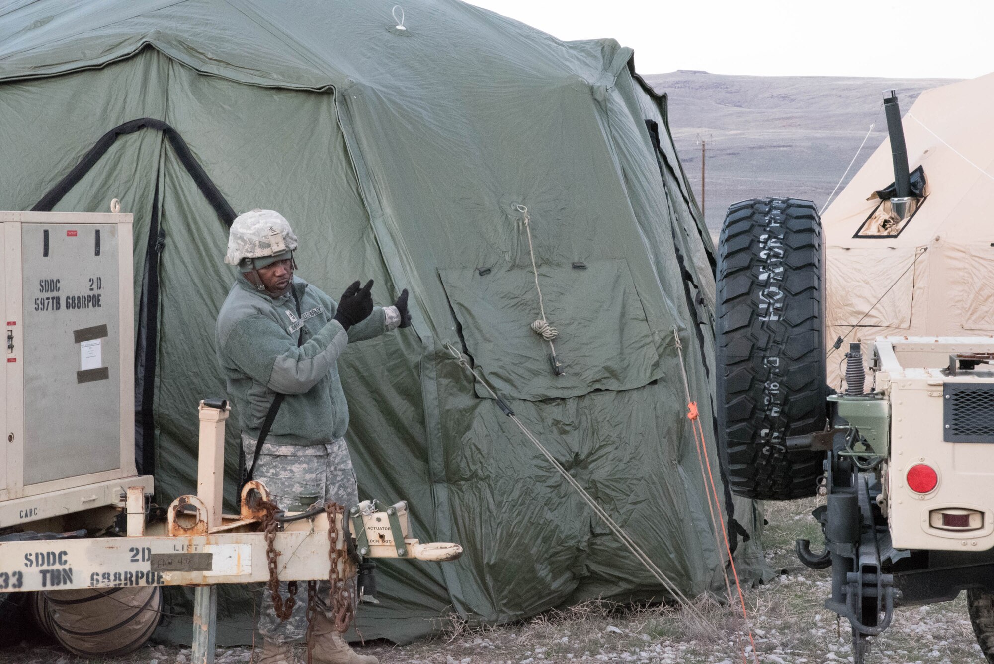 U.S. Army Sgt. First Class Michael Slater, clearance platoon sergeant for the 688th Rapid Port Opening Element, directs the movement of support equipment at Amedee Army Airfield, Calif., March 7, 2016. The 688th RPOE is working in conjunction with the Kentucky Air National Guard’s 123rd Contingency Response Group and a team from the Defense Logistics Agency to operate Joint Task Force-Port Opening Sangala during a week-long exercise called Operation Lumberjack. The objective of the JTF-PO is to establish an aerial port of debarkation, provide initial distribution capability and set up warehousing for distribution beyond a forward node. (Kentucky Air National Guard photo by 1st Lt. James Killen)