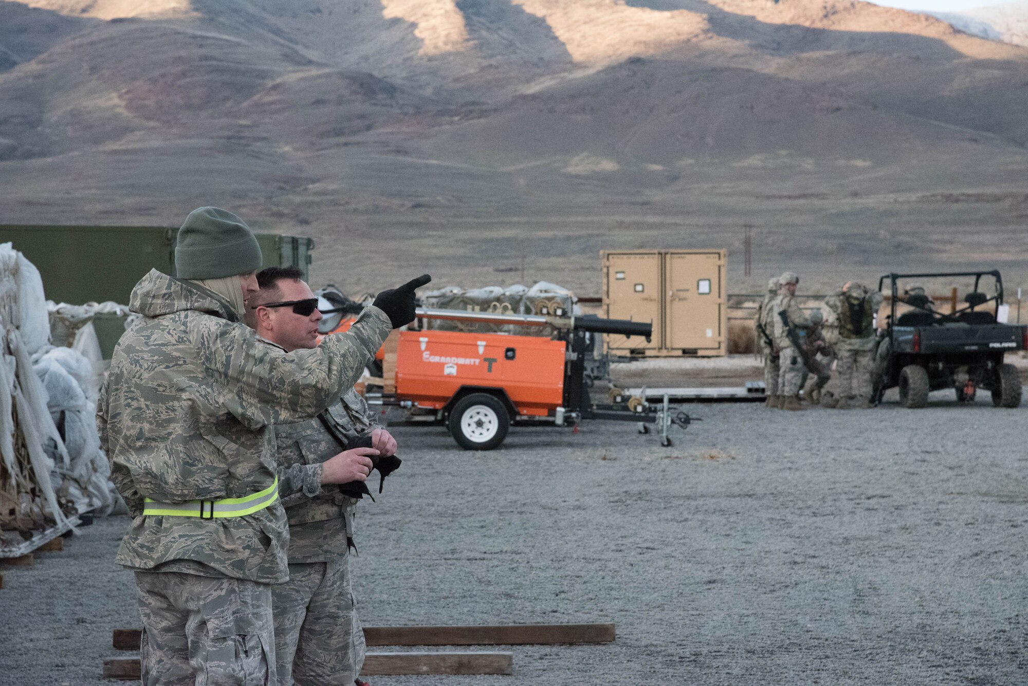 Airmen from the Kentucky Air National Guard’s 123rd Contingency Response Group discuss the movement of equipment delivered by airlift to Amedee Army Airfield, Calif., March 7, 2016. 123rd CRG is working in conjunction with the U.S. Army’s 688th Rapid Port Opening Element and a team from the Defense Logistics Agency to operate Joint Task Force-Port Opening Sangala during a week-long exercise called Operation Lumberjack. The objective of the JTF-PO is to establish an aerial port of debarkation, provide initial distribution capability and set up warehousing for distribution beyond a forward node. (Kentucky Air National Guard photo by 1st Lt. James Killen)
