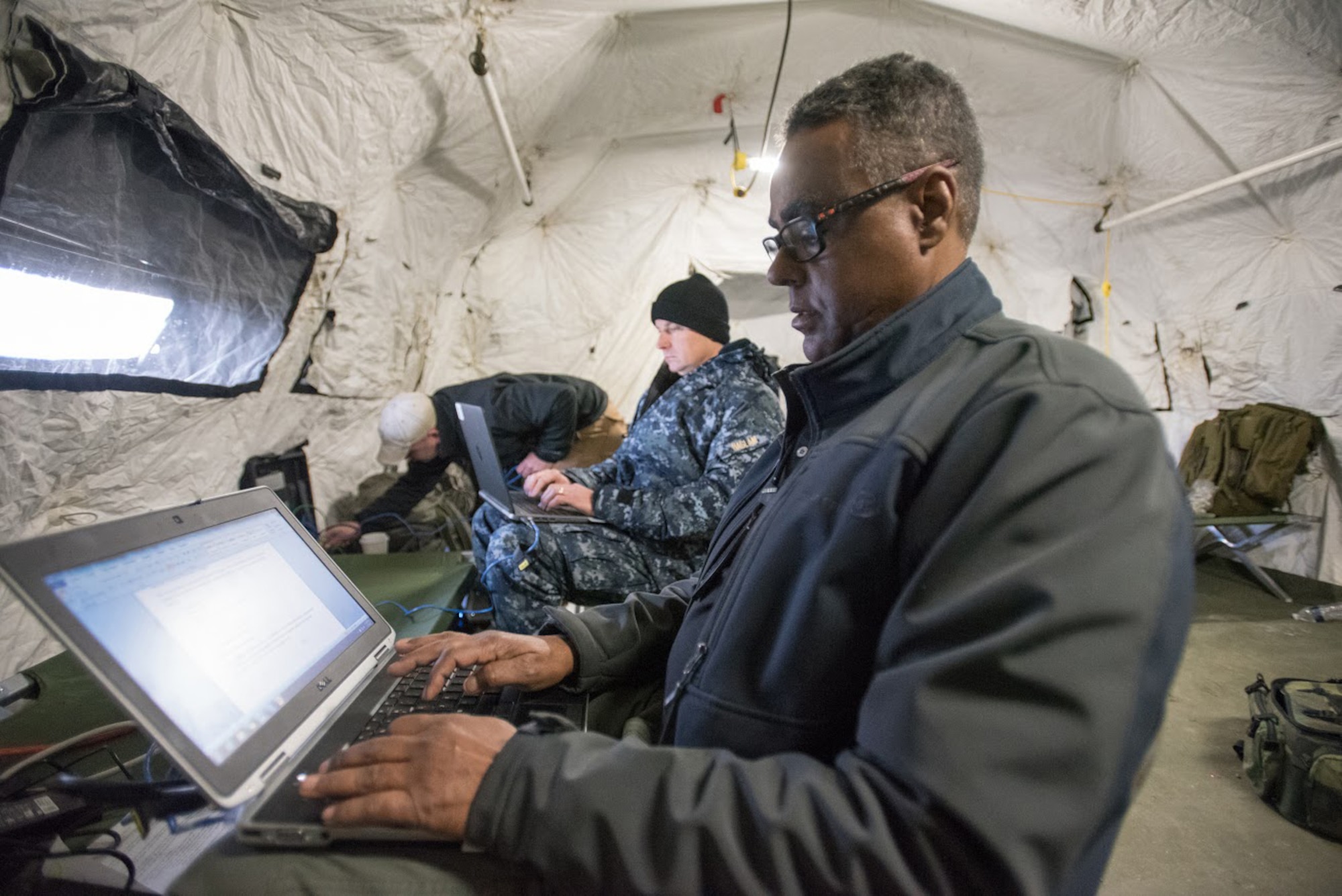 Facial Liban (right), a traffic management specialist for the Defense Logistics Agency's Support Team Black, and Capt. Paul Haslam, Black Team commander, prepare operational reports at Amedee Army Airfield, Calif., on March 7, 2016. The Defense Logistics Agency is working in conjunction with the Kentucky Air National Guard’s 123rd Contingency Response Group and the U.S. Army’s 688th Rapid Port Opening Element to operate Joint Task Force-Port Opening Sangala during a week-long exercise called Operation Lumberjack. The objective of the JTF-PO is to establish an aerial port of debarkation, provide initial distribution capability and set up warehousing for distribution beyond a forward node. (Kentucky Air National Guard photo by Master Sgt. Phil Speck)