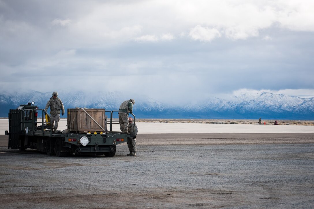 Aerial porters from the Kentucky Air National Guard’s 123rd Contingency Response Group set up a Halvorsen Loader to unload cargo from aircraft at Amedee Army Airfield, Calif., during Operation Lumberjack on March 7, 2016. The Kentucky Air National Guard’s 123rd CRG, the U.S. Army’s 688th Rapid Port Opening Element and a team from the Defense Logistics Agency are all participating in the week-long exercise. (Kentucky Air National Guard photo by Master Sgt. Phil Speck)