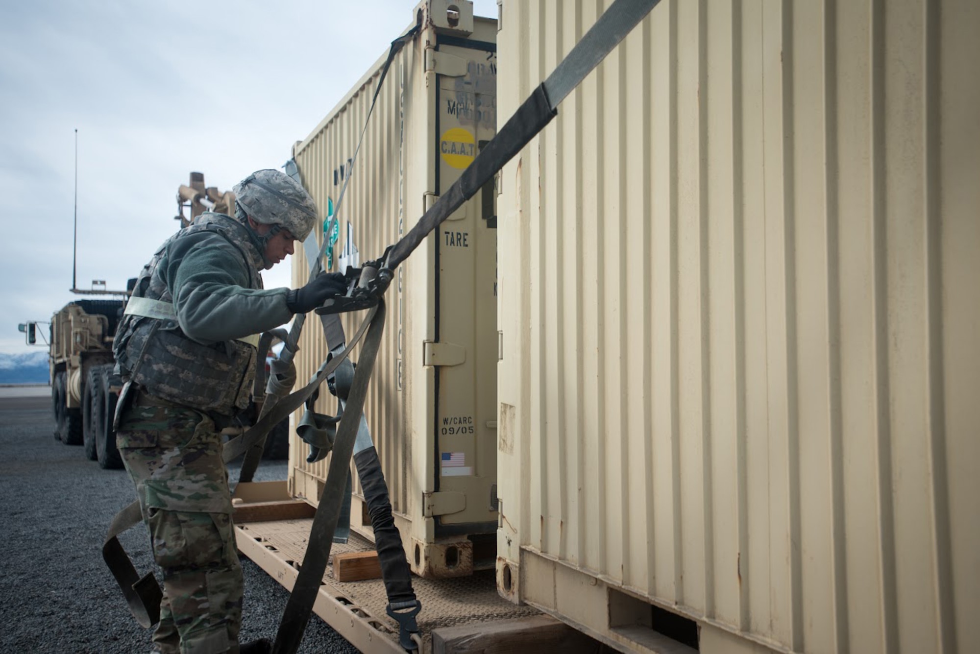 U.S. Army Pfc. Kenneth Gaud, a cargo specialist for the 688th Rapid Port Opening Element, straps cargo to a pallet at Amedee Army Airfield, Calif., during Operation Lumberjack on March 8, 2016. The 688th RPOE, the Kentucky Air National Guard’s 123rd Contingency Response Group and a team from the Defense Logistics Agency are all participating in the week-long exercise. (Kentucky Air National Guard photo by Master Sgt. Phil Speck)