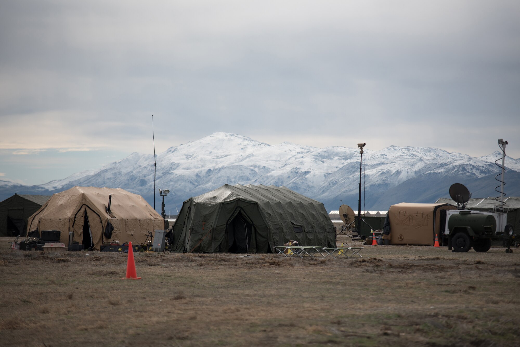 Operations tents set up by the Kentucky Air National Guard’s 123rd Contingency Response Group sit along the Sierra Nevada Mountains at Amedee Army Airfield, Calif., on March 8, 2016. The 123rd CRG is working in conjunction with the U.S. Army’s 688th Rapid Port Opening Element and a team from the Defense Logistics Agency to operate Joint Task Force-Port Opening Sangala during a week-long exercise called Operation Lumberjack. The objective of the JTF-PO is to establish an aerial port of debarkation, provide initial distribution capability and set up warehousing capability for distribution beyond a forward node. (Kentucky Air National Guard photo by Master Sgt. Phil Speck)