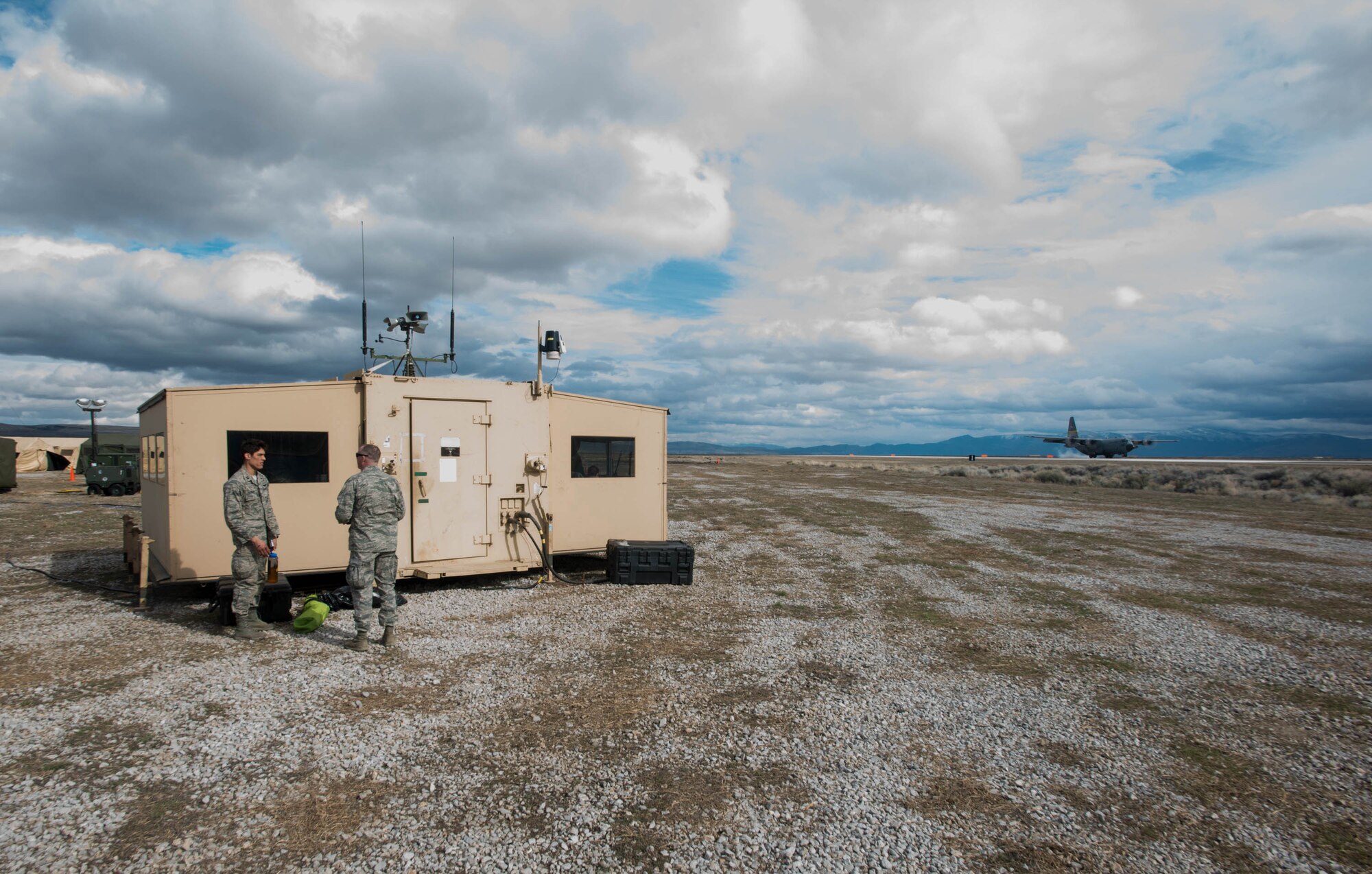 A Wyoming Air National Guard C-130 Hercules lands next to the 123rd Contingency Response Group’s Hardened Expeditionary Light Air Mobile Shelter at Amedee Army Airfield, Calif., during Operation Lumberjack on March 9, 2016. The 123rd CRG, a unit of the Kentucky Air National Guard, is working in conjunction with the U.S. Army’s 688th Rapid Port Opening Element and a team from the Defense Logistics Agency to operate Joint Task Force-Port Opening Sangala during the week-long exercise. The objective of the JTF-PO is to establish an aerial port of debarkation, provide initial distribution capability and set up warehousing capability for distribution beyond a forward node. (Kentucky Air National Guard photo by Master Sgt. Phil Speck)