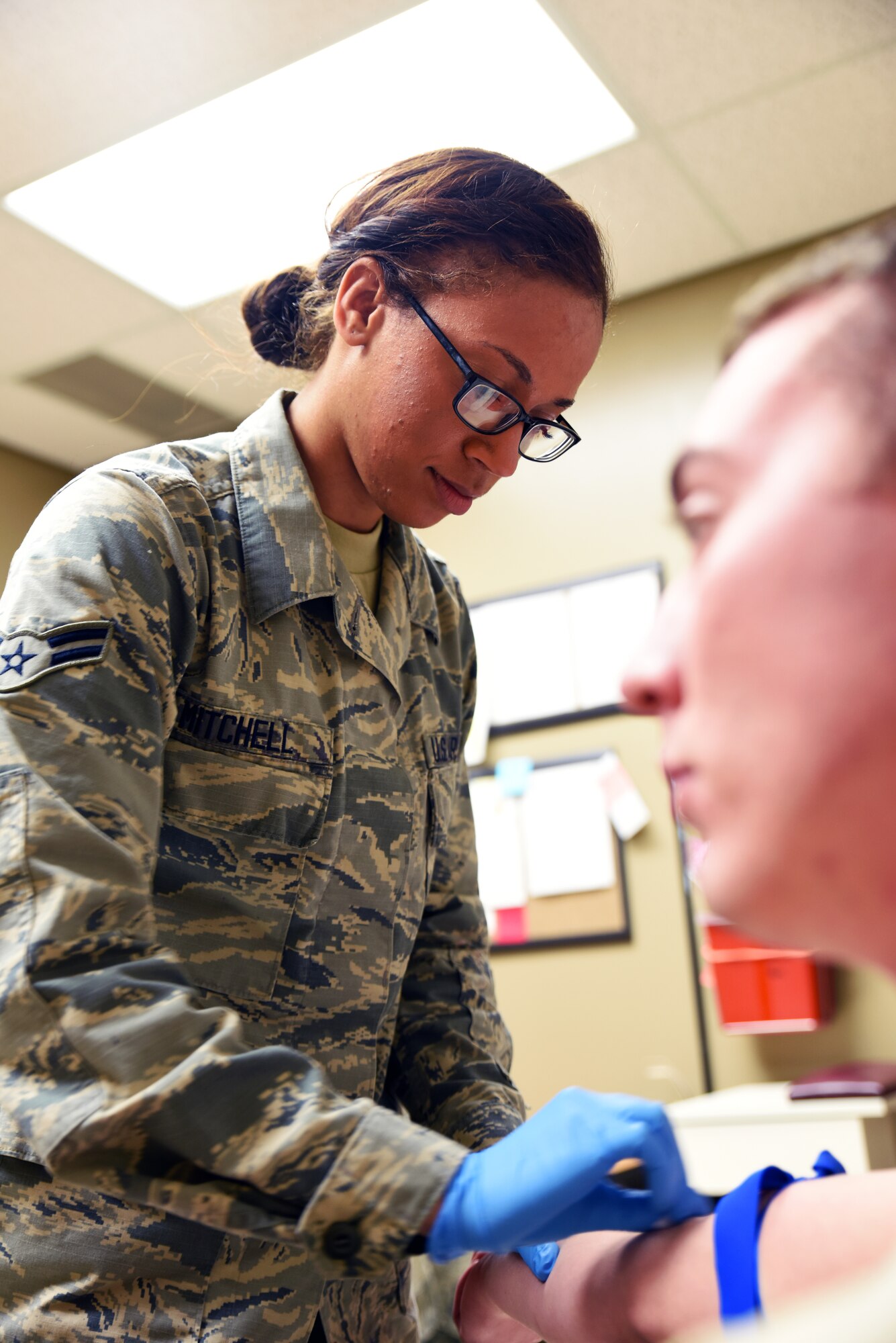 Airman 1st Class Devyn Mitchell draws blood from an Airman March 6, 2016, during regularly scheduled drill at Ebbing Air National Guard Base, Fort Smith, Ark. Mitchell is a medical technician with the 188th Medical Group and has been with the 188th for a year. (U.S. Air National Guard photo by Senior Airman Cody Martin/Released)