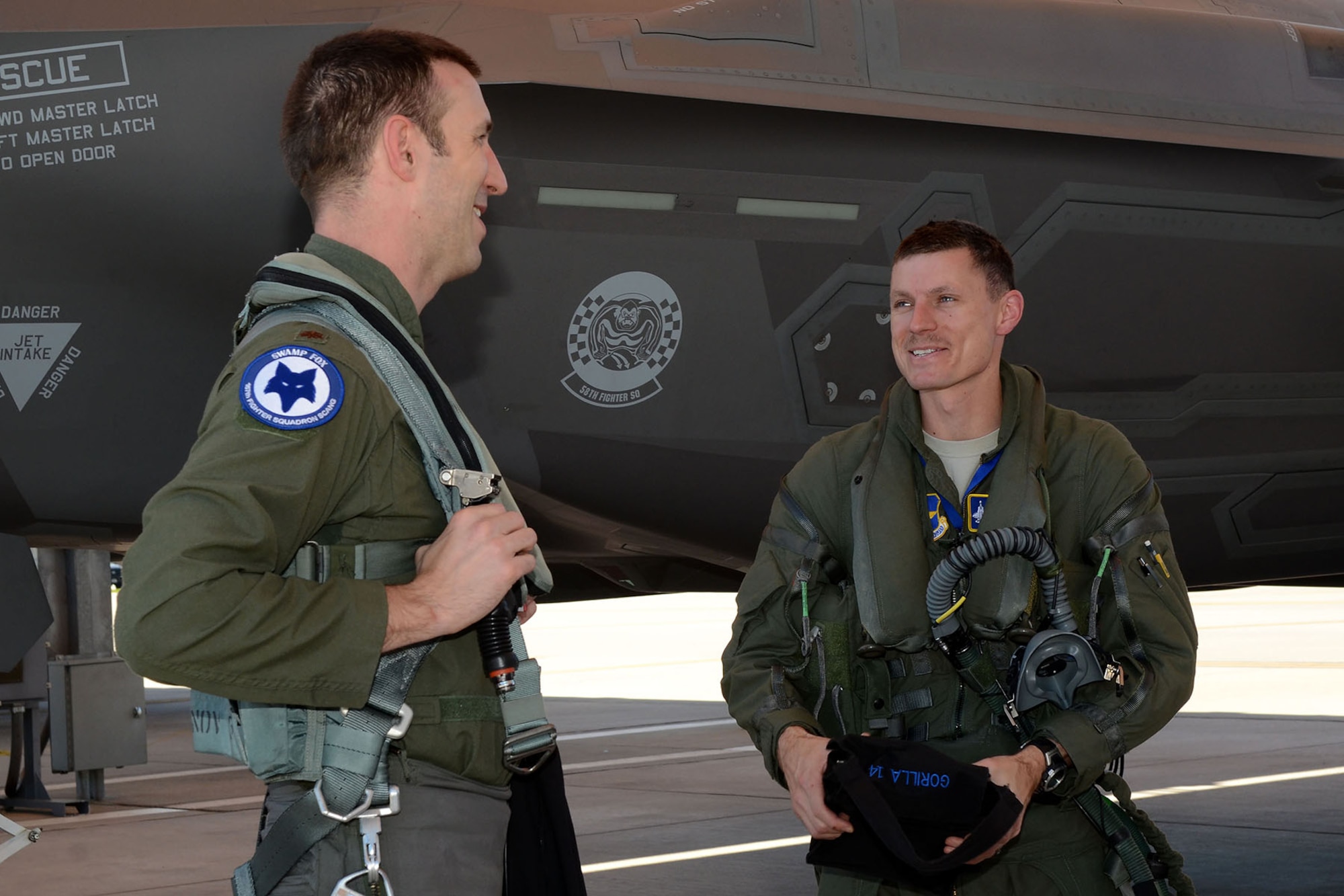 U.S. Air Force Lt. Col. Jon Snyder, an F-35 Lightning II fighter pilot assigned to the 33rd Fighter Wing from Eglin Air Force Base, Fla., is greeted by Maj. Justin Mock, an F-16 Fighting Falcon fighter pilot assigned to the 169th Fighter Wing of the South Carolina Air National Guard, at McEntire Joint National Guard Base, S.C., March 22, 2016.  The pilots conducted 4th and 5th generation integration fighter training, during local training missions, Mar. 21st and 22nd. (U.S. Air National Guard photo by Senior Airman Ashleigh Pavelek)
