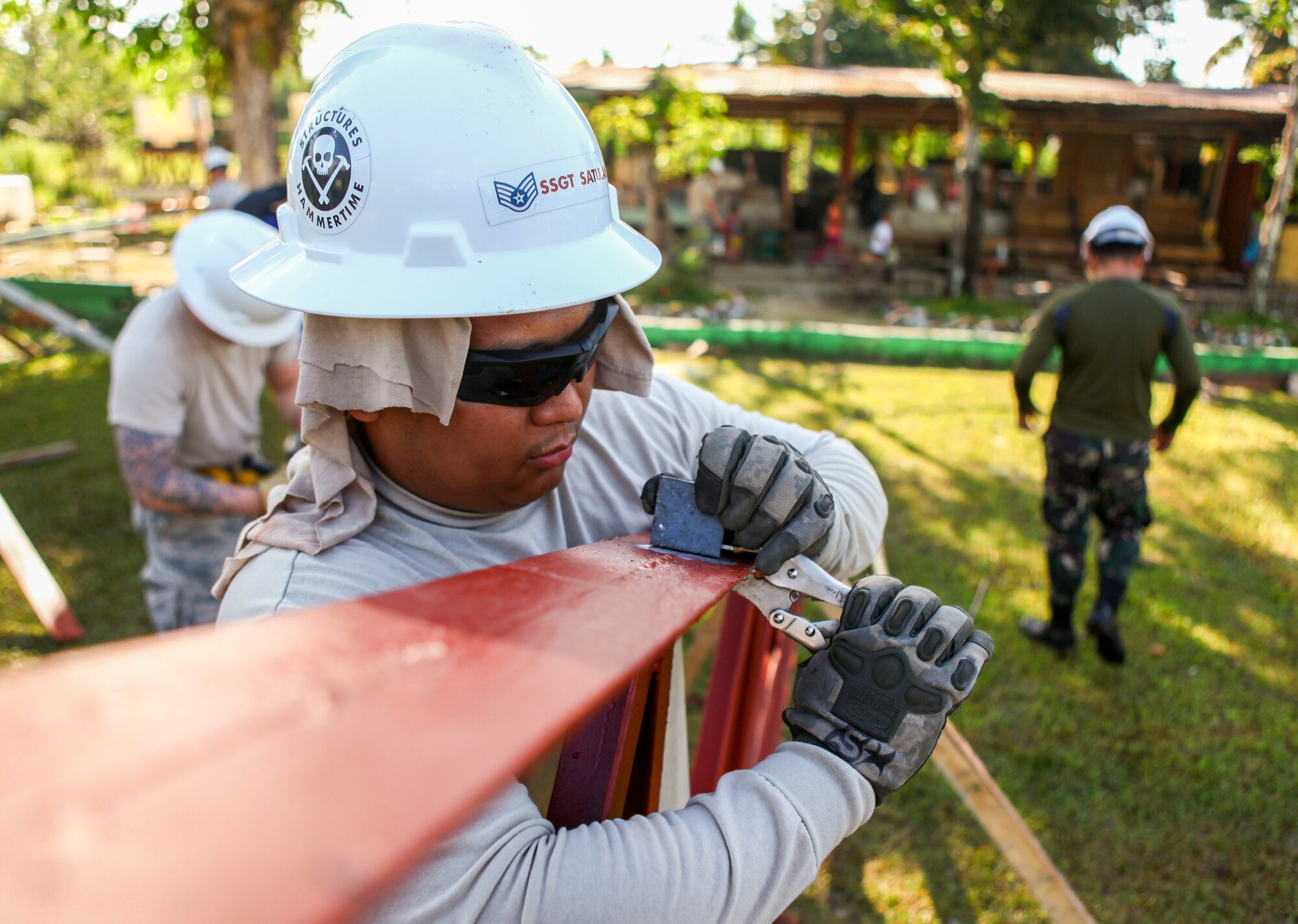 U.S. Air Force Staff Sgt. Rawlinson Satulan, engineer, assigned to the 673rd Expeditionary Engineer Squadron, adjusts a portion of a roof frame for a new classroom being built at the Jaena Norte Elementary School, in Capiz, Philippines, during Exercise Balikatan, March 29, 2016. The construction project is one of multiple HCAs taking place during this year's exercise, designed to improve the quality of life for the local populace and strengthen the bond between our two nations. Balikatan, which means "shoulder to shoulder" in Filipino, is an annual bilateral training exercise aimed at improving the ability of Philippine and U.S. military forces to work together during planning, contingency and humanitarian assistance and disaster relief operations. (U.S. Marine Corps Combat Camera photo by Cpl. Hilda M. Becerra / Released)
