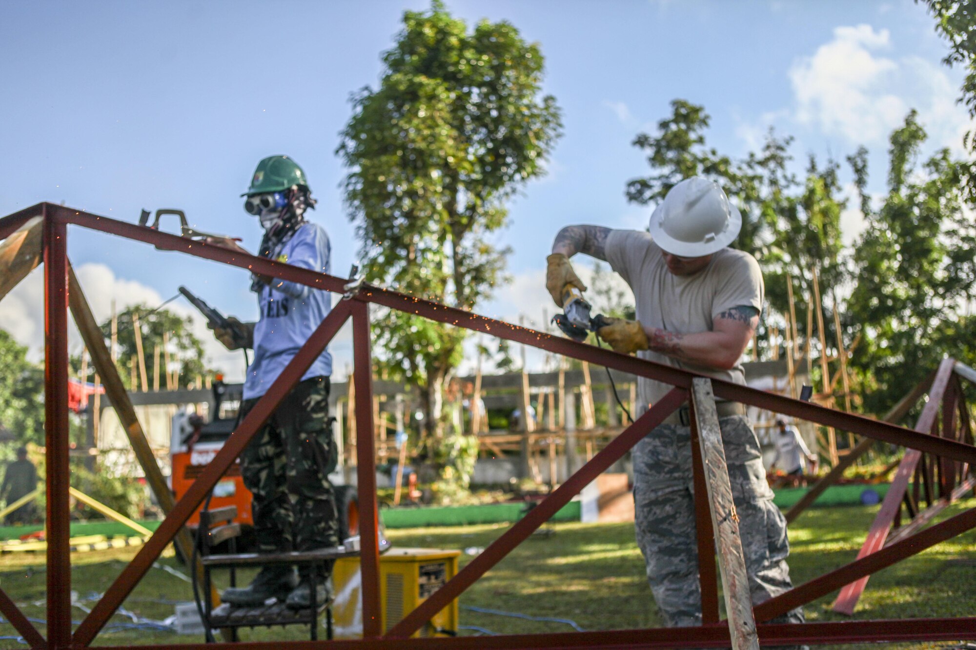 U.S. Air Force Senior Airman Josiah Sorrels, right, engineer, assigned to the 673rd Expeditionary Engineer Squadron, and Philippine army soldier Pfc. Randy Quidores, left, engineer, assigned to the 552nd Engineer Construction Battalion, help build a classroom for the Jaena Norte Elementary School, in Capiz, Philippines, during Exercise Balikatan, March 29, 2016. The construction project is one of multiple HCAs taking place during this year's exercise, designed to improve the quality of life for the local populace and strengthen the bond between our two nations. Balikatan, which means "shoulder to shoulder" in Filipino, is an annual bilateral training exercise aimed at improving the ability of Philippine and U.S. military forces to work together during planning, contingency and humanitarian assistance and disaster relief operations.  (U.S. Marine Corps Combat Camera photo by Cpl. Hilda M. Becerra / Released)