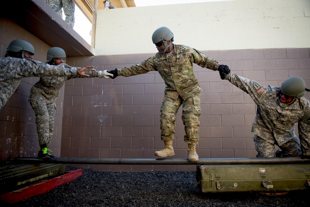 Soldiers participating in Operational Contract Support Joint Exercise 2016 work together to complete a leadership reaction course obstacle at Fort Bliss, Texas, March 24, 2016 Air Force photo by Tech. Sgt. Manuel J.Martinez