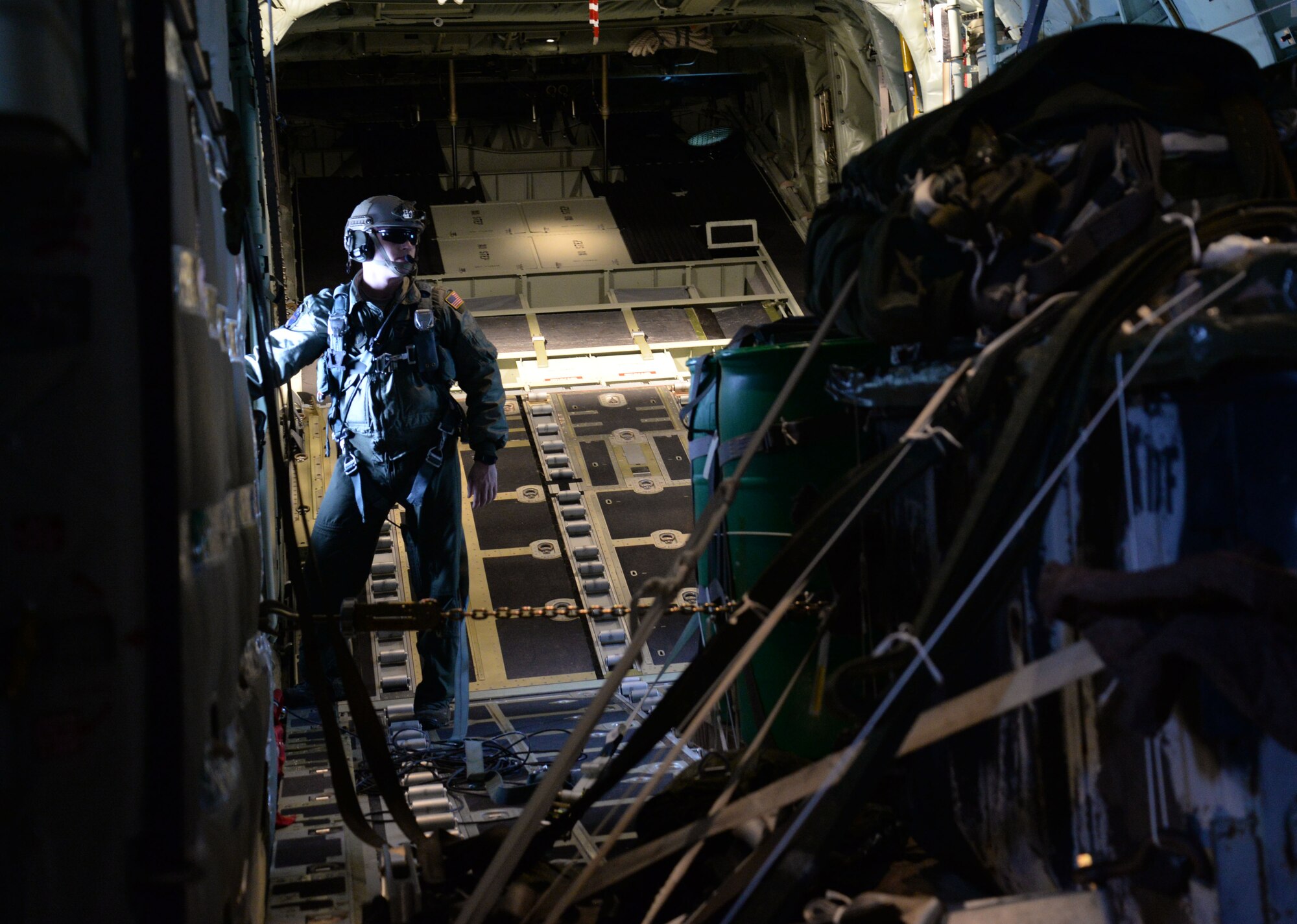A U.S. Air Force Special Operation Squadron loadmaster waits for the green light to launch an MC-130J Commando II airdrop March 24, 2016, from RAF Mildenhall, England. Loadmasters coordinate with the flight crew to efficiently and accurately deliver cargo in various flight conditions. By utilizing clear communication and performing timely procedures the crew, assigned to RAF Mildenhall, England, is capable of a successful mission. (U.S. Air Force photo by Senior Airman Justine Rho/Released)
