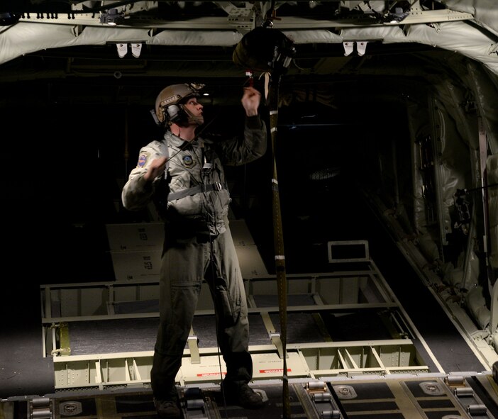 A U.S. Air Force 67th Special Operation Squadron loadmaster prepares a parachute for an MC-130J Commando II airdrop March 24, 2016, off the coast of the Norfolk Sea. The MC-130J aircrew, assigned to RAF Mildenhall, England, performed various tasks that showcased their proficiency and the versatility of the aircraft. (U.S. Air Force photo by Senior Airman Justine Rho/Released)