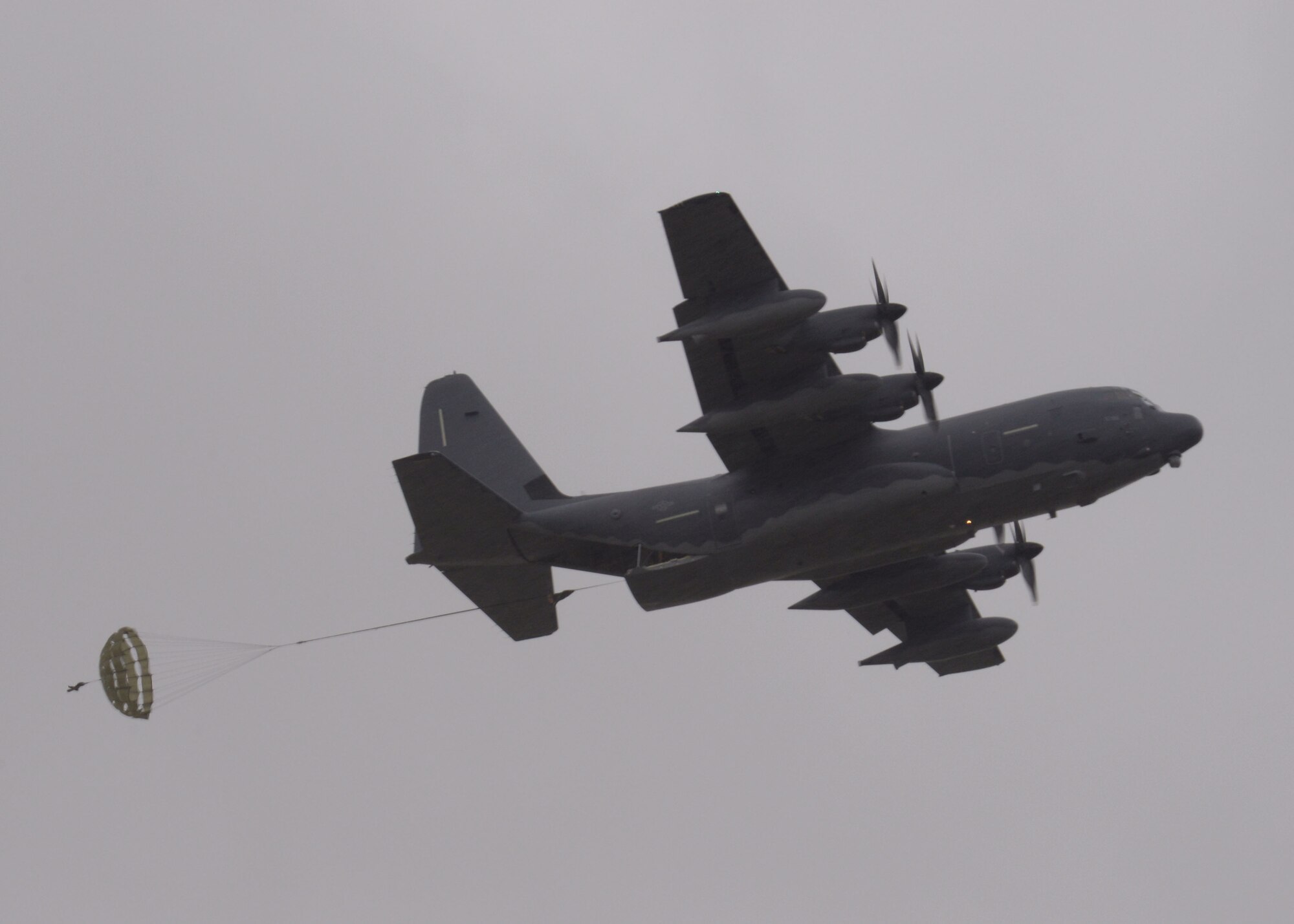 Cargo is deployed from an MC-130J Commando II March 24, 2016, over RAF Sculthorpe in Norwich, England. The MC-130J, assigned to RAF Mildenhall, England, performed an over water combat mission profile prior to the air drop. The mission illustrated the aircrew’s proficiency and the versatility of the MC-130J. (U.S. Air Force photo by Karen Abeyasekere /Released)