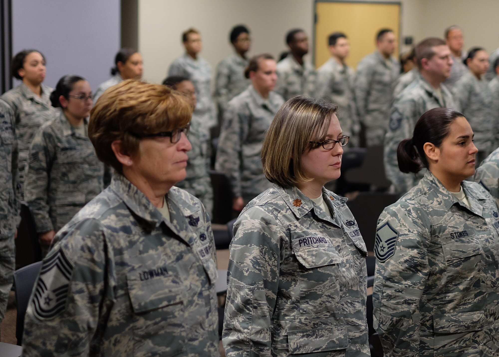 Airmen with the 931st Air Refueling Wing, stand at attention April 2, 2016, at McConnell Air Force Base, Kansas. The group is comprised mostly of 931st Force Support Squadron Airmen and gathered together to celebrate the promotion of their first senior NCO since the creation of the 931 FSS services flight, signifying growth as a unit. (U.S. Air Force photo by Senior Airman Preston Webb)
