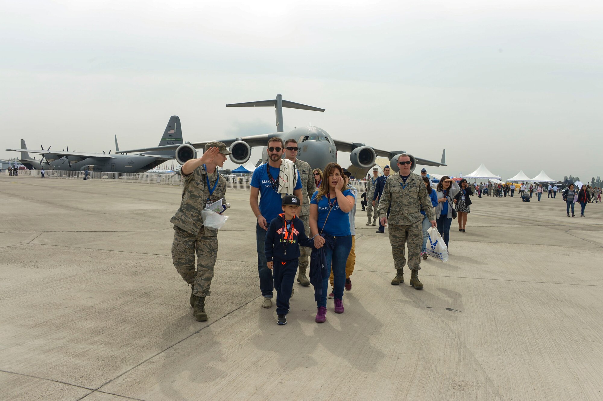 Capt. Ben Worker, U.S. Embassy in Chile, shows groups of children and their caretakers to the F-22 Raptor Static display during the at the 2016 FIDAE Air and Space Trade Show in Santiago, Chile, April 1, 2016. Airmen from around the U.S. came to Chile to participate in the FIDAE Air Show 2016, from March 29– April 3, 2016.  During their stay, they made time to connect one-on-one with members of the community and hosted children from the Make-A-Wish and Teletón Foundations. (U.S. Air Force photo by Tech. Sgt. Heather Redman/Released)