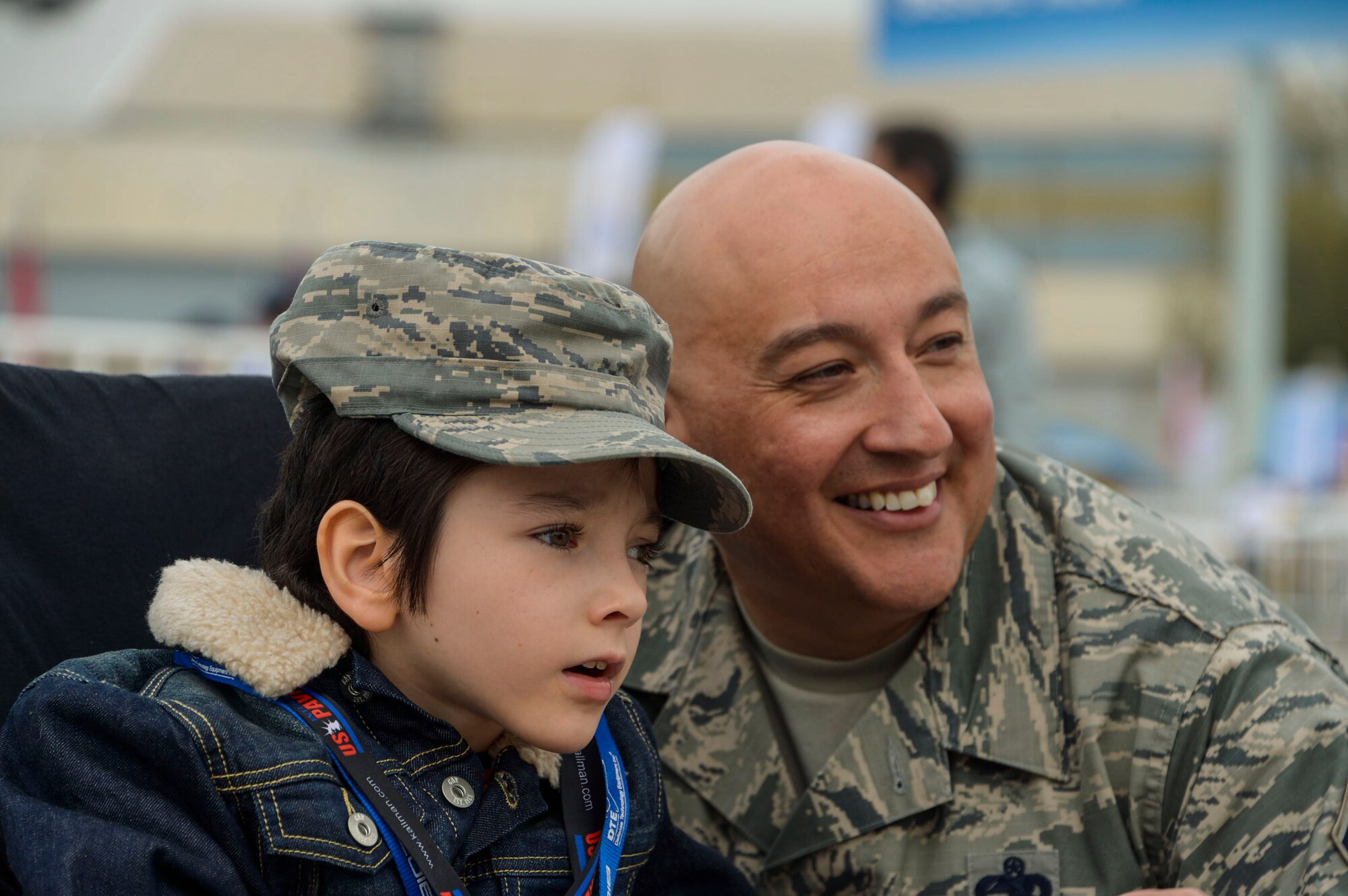 Chief Master Sgt. Jose Barraza, 12th Air Force (Air Forces Southern) command chief, shows a young boy the aircraft on display at the 2016 FIDAE Air and Space Trade Show in Santiago, Chile, April 1, 2016. Airmen from around the U.S. came to Chile to participate in the FIDAE Air Show 2016, from March 29– April 3, 2016.  During their stay, they made time to connect one-on-one with members of the community and hosted children from the Make-A-Wish and Teletón Foundations. (U.S. Air Force photo by Tech. Sgt. Heather Redman/Released)