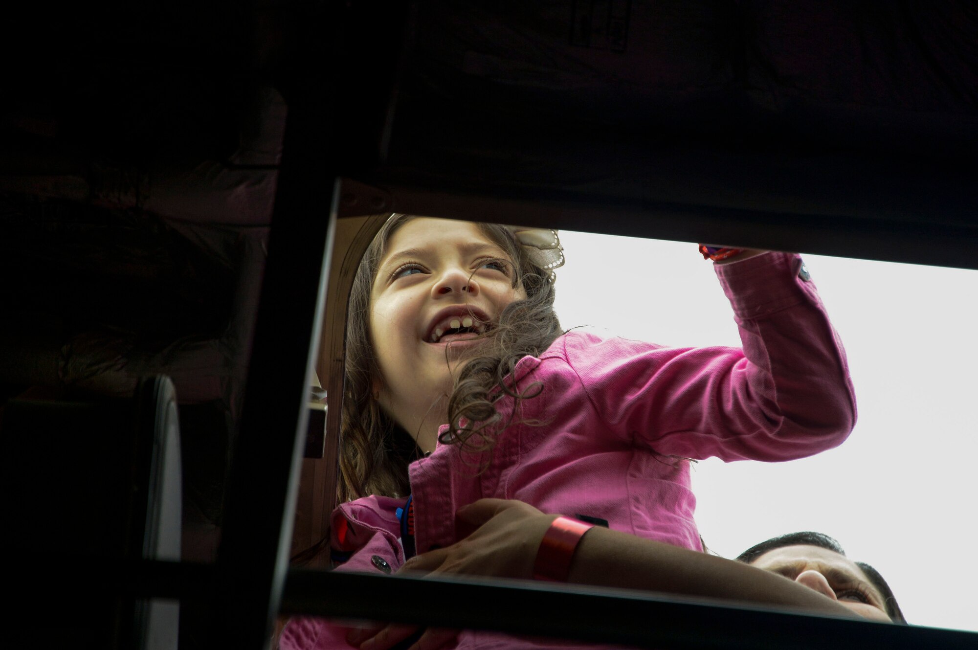 A young girl looks out the top of a C-17 Globemaster III from Wright-Patterson AFB, Ohio during the at the 2016 FIDAE Air and Space Trade Show in Santiago, Chile, April 1, 2016. Airmen from around the U.S. came to Chile to participate in the FIDAE Air Show 2016, from March 29– April 3, 2016.  During their stay, they made time to connect one-on-one with members of the community and hosted children from the Make-A-Wish and Teletón Foundations. (U.S. Air Force photo by Tech. Sgt. Heather Redman/Released)