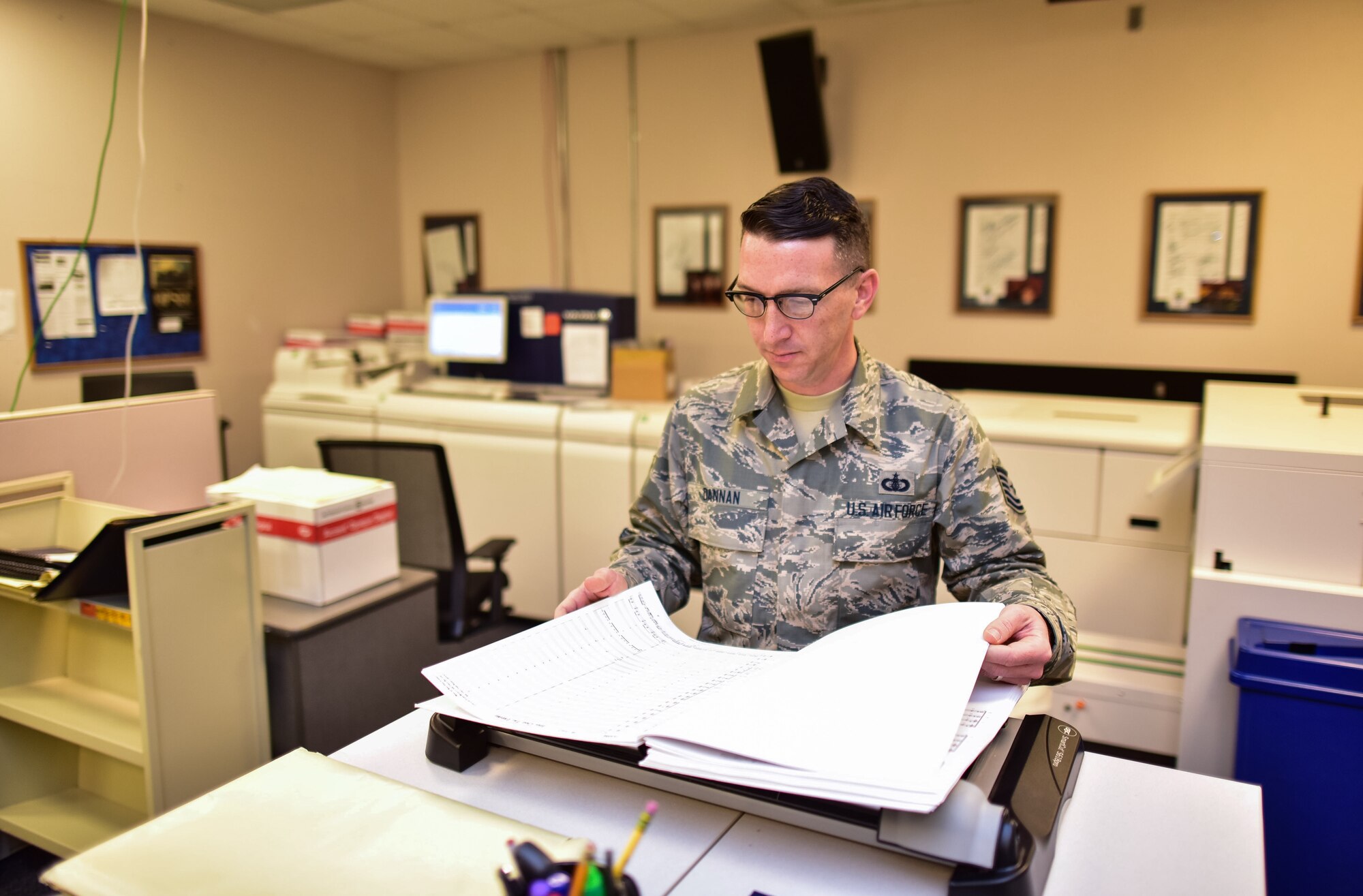 Technical Sgt. Matthew Dannan prepares a score for an upcoming
performance before sending it off to the conductor. He holds a Master's
Degree in Library Science and serves as the Chief Music Librarian for the
U.S. Air Force Band. (U.S. Air Force photo by Senior Master Sgt. Kevin
Burns/released)