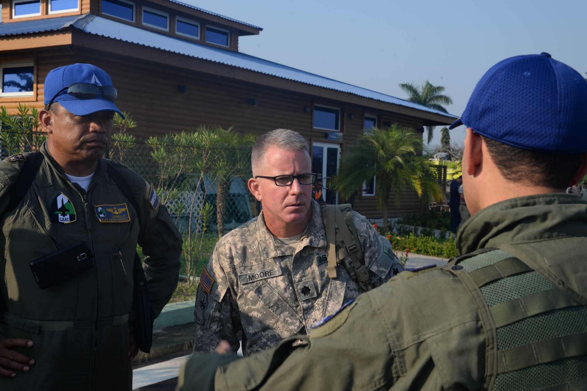 U.S. Army Lt. Col. Daniel Moore talks with Honduran Lt. Col. Julio Hernandez and other members of the Honduran Air Force April 1, 2016, Tela, Honduras, to coordinate aerial-firefighting efforts along the northern coast of Honduras. Honduran President Juan Orlando Hernandez requested the support of U.S. air assets to help the Honduran Fire Department, Air Force and Army, which were already engaged in helping extinguish the forest fire near Tela. (U.S. Air Force photo by Staff Sgt. Westin Warburton/ Released)