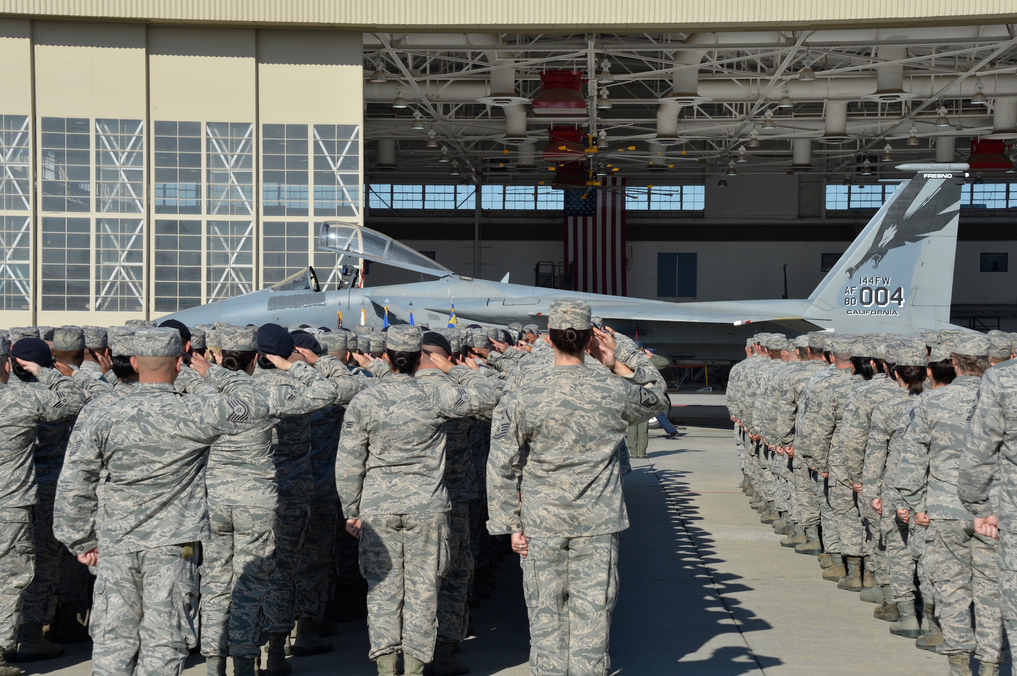 Airmen salute in formation during the 144th Fighter Wing Change of Command ceremony here April 2, 2016. The incoming commander Col. Reed Drake assumed command after outgoing commander  Brig. Gen. Clay Garrison relinquished command by the passing of the guidon. (U.S. Air National Guard photo by Tech. Sgt. Charles Vaughn)