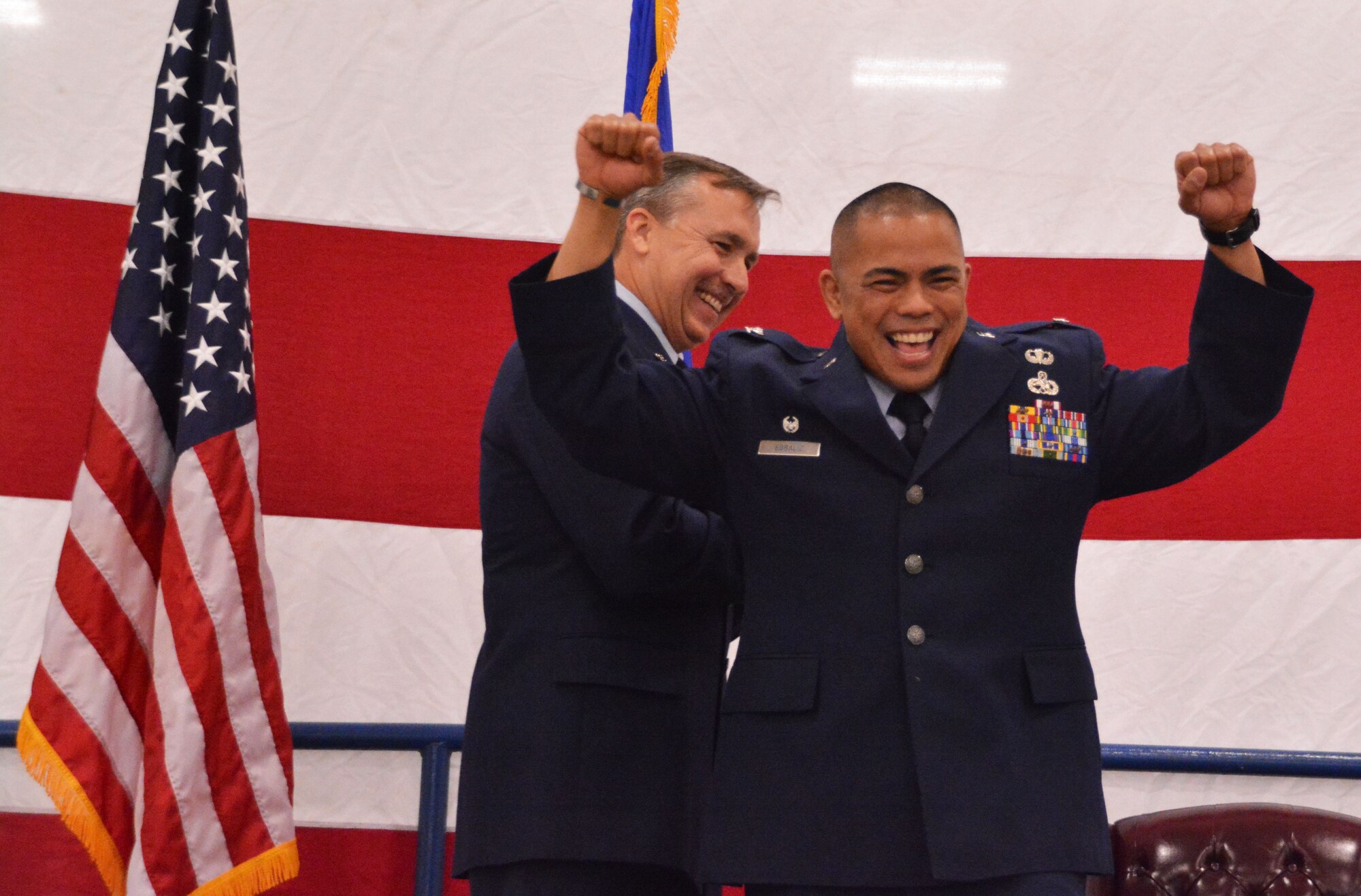 Col. Michael Egbalic, 301st Maintenance Group commander, raises his fists in celebration April 2 after promoting to colonel here. Sixteenth century Spanish King Ferdinand created "cabo de colunela's," or colonels, when he reorganized his army. The French and British later copied his idea.
