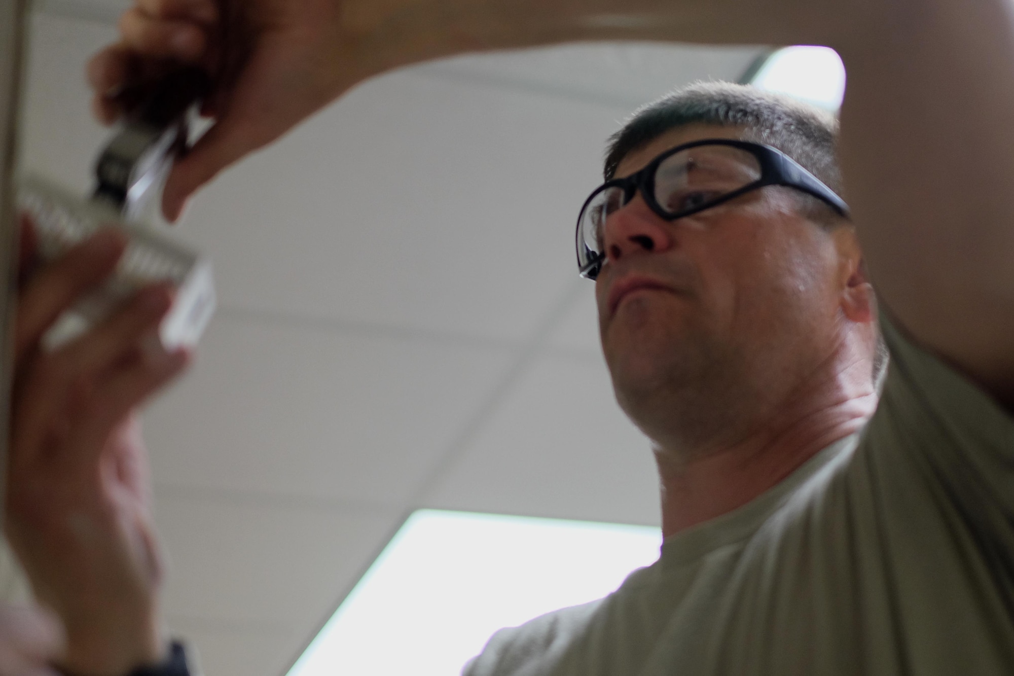 Staff Sgt. Bruce Bennet, 931st Civil Engineer Squadron Water and Liquid Fuels technician, removes a thermostat from a wall being removed April 2, 2016, in Building 1 at McConnell Air Force Base, Kansas. The 931 CES renovated offices in Building 1 to create a new command suite for the 931st. (U.S. Air Force photo by Senior Airman Preston Webb)