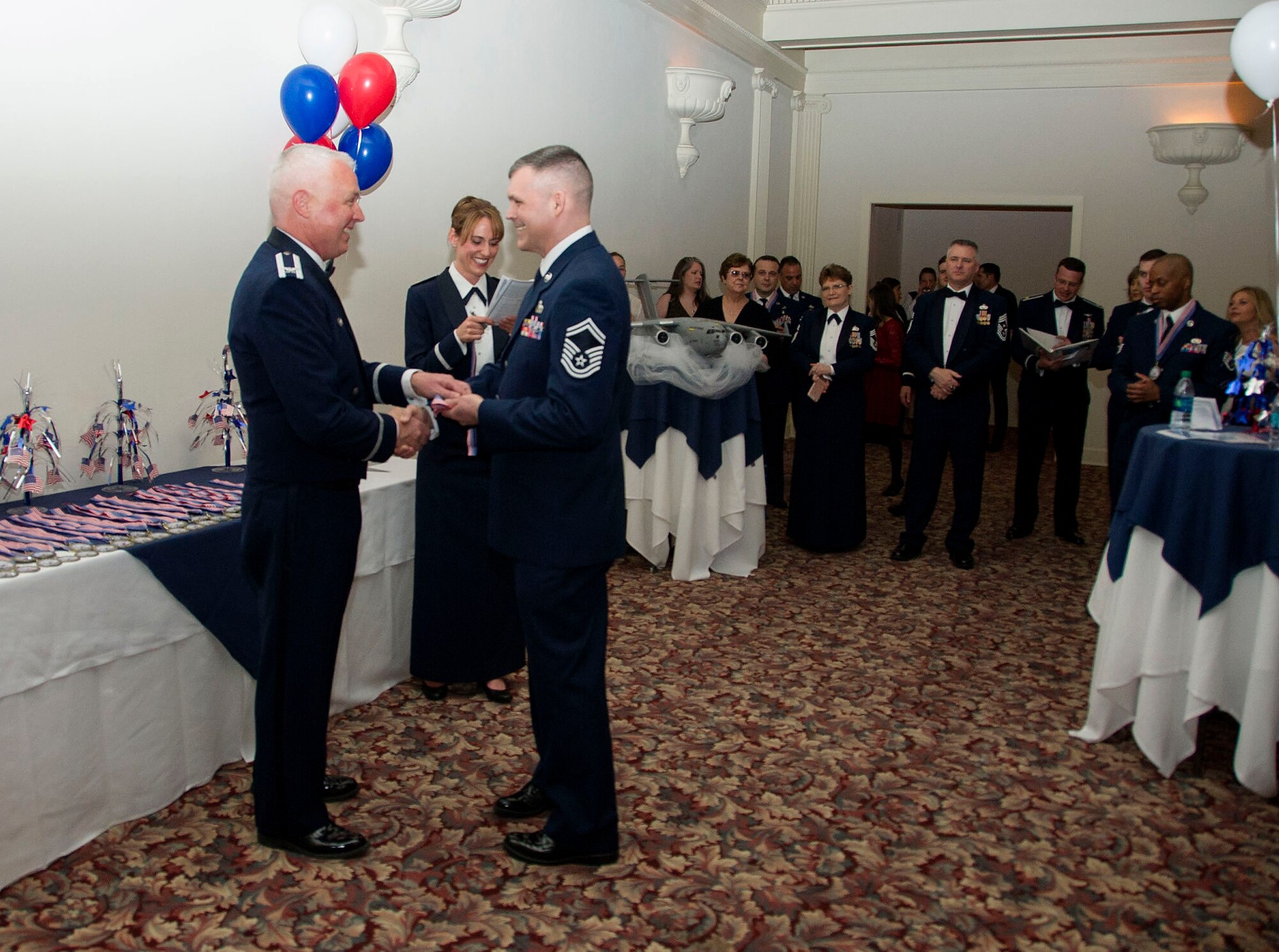 Col. Scott McLaughlin, 446th Airlift Wing Commander, give Senior Master Sgt. Marvin Hitt, 446th Aircraft Maintenance Squadron, a medallion during the 2016 Annual Awards Banquet Medallion Ceremony at The Landmark Hotel in Tacoma, Washington April 2, 2016. Hitt received the award for Senior NCO of the year. (U.S. Air Force Reserve photo by Staff Sgt. Madelyn McCullough)