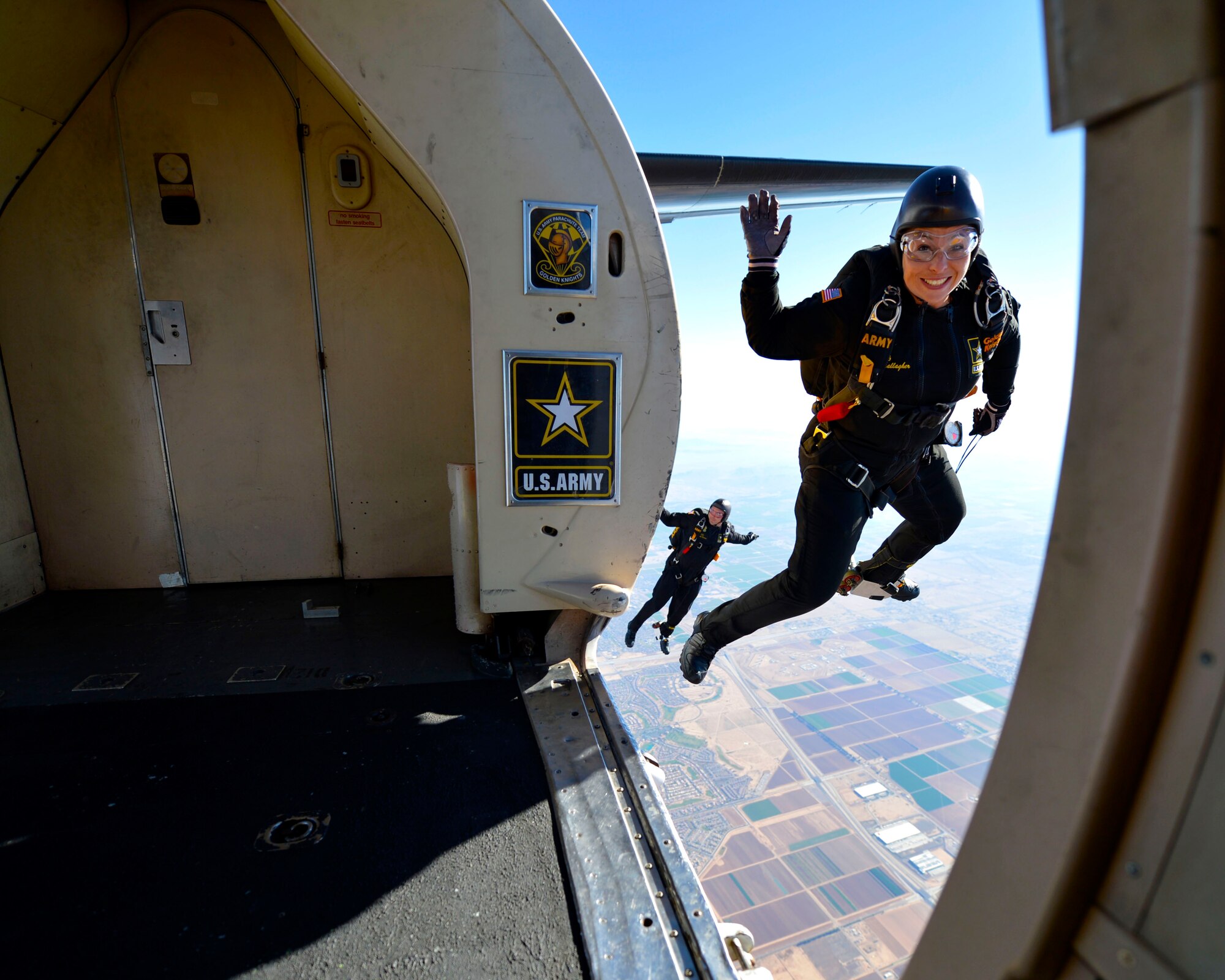 Army Staff Sgt. Sherri Jo Gallagher, a member of the U.S. Army's Golden Knights waves as she exits the plane during the Luke Air Force Base air show, 75 Years of Airpower Apr. 1, 2016.   (U.S. Air Force photo by Senior Airman James Hensley)