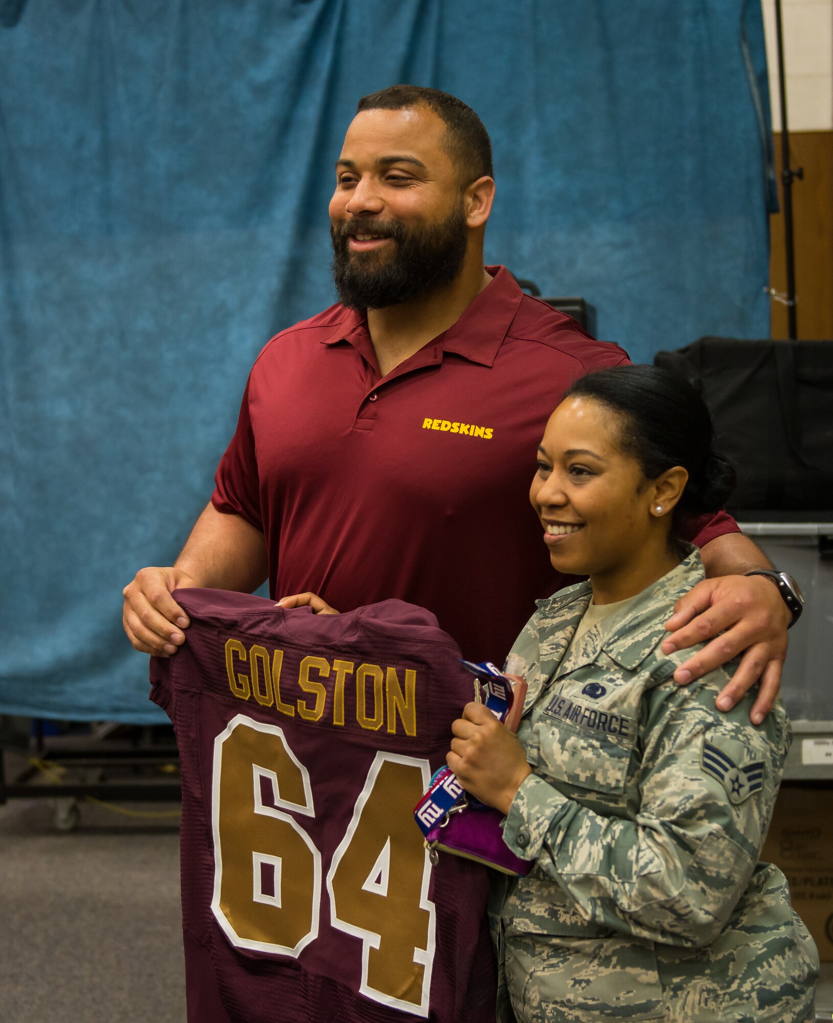 Kedric Golston, a professional football player with the Washington Redskins, poses for a picture with a reservist from the 459th Air Refueling Wing before the wing’s Annual Prayer Breakfast on April 3, 2016 at Joint Base Andrews, Md. Golston spoke about the importance of his faith in his success to a group of more than 150 reservists from the 459th. (U.S. Air Force photo/Staff Sgt. Scott Pauley)
