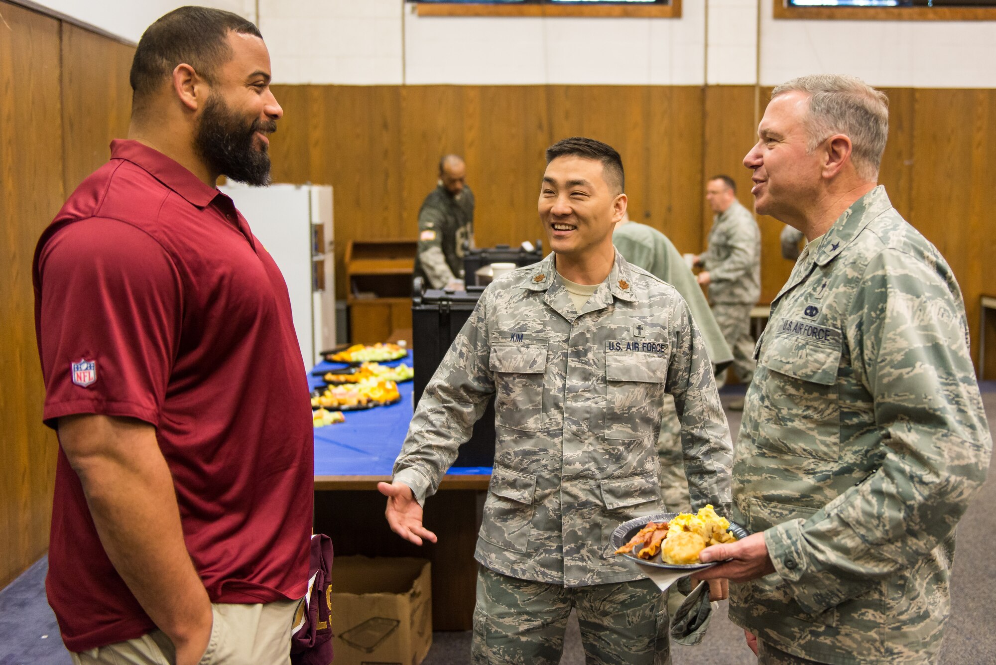 Kedric Golston, a professional football player with the Washington Redskins, laughs with Chaplain (Brig. Gen.) Steven Schaick, U.S. Air Force deputy chief of chaplains, and Chaplain (Maj.) Joshua Kim, chaplain for the 459th Air Refueling Wing, before the 459th ARW’s Annual Prayer Breakfast on April 3, 2016 on Joint Base Andrews, Md. More than 150 reservists from the 459th attended the second annual breakfast. (U.S. Air Force photo/Staff Sgt. Scott Pauley)