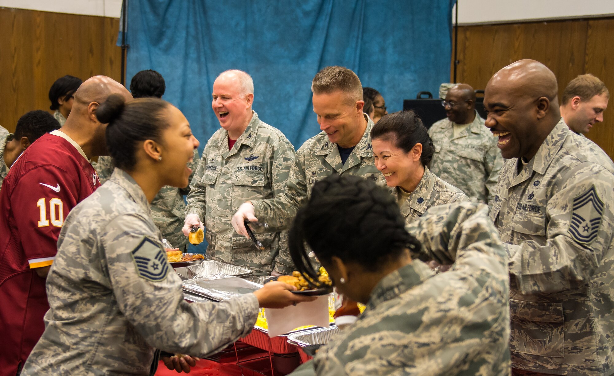 Leadership from the 459th Air Refueling Wing serve breakfast to attendees at the annual Prayer Breakfast which featured guest speaker Kedric Golson, a professional football player with the Washington Redskins, and a benediction from Brig. Gen. Steven Schaick, USAF deputy chief of chaplains, on April 3, 2016 on Joint Base Andrews, Md. Golston spoke about the importance of his faith in his success to a group of more than 150 reservists from the 459 ARW during the annual breakfast.