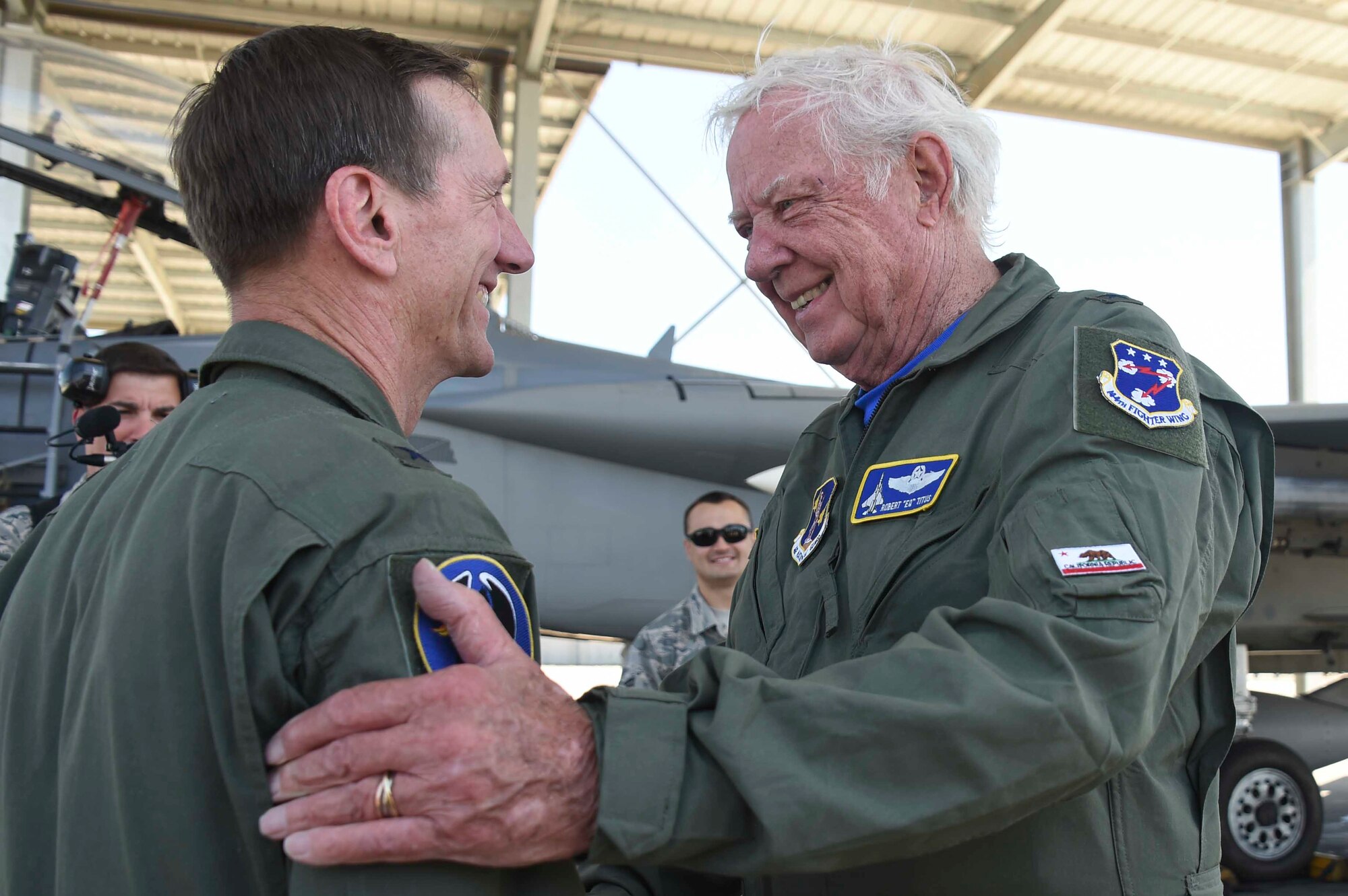 U.S. Air Force Brig. Gen. (ret.) Robert Earthquake Titus shakes hands with U.S. Air Force Brig. Gen. Clay Garrison, 144th Fighter Wing commander at the Fresno Air National Guard Base, April 1, 2016. Titus is the 144th FW's 3rd Annual Heritage Week honored guest, who shared his personal experiences as a fighter pilot with the 144th FW Airmen. (U.S. Air National Guard photo by Senior Airman Klynne Pearl Serrano)