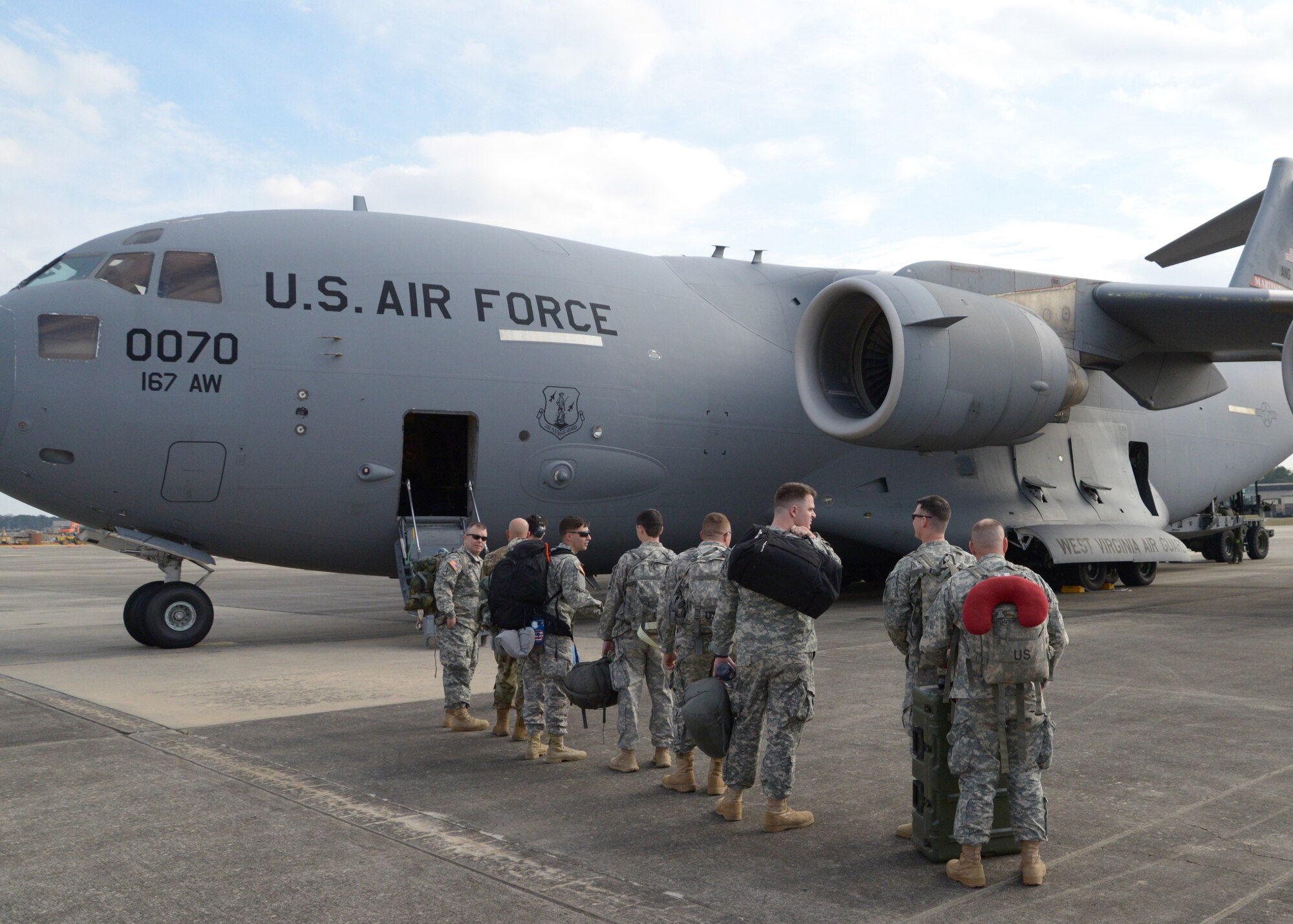 National Guard Soldiers assigned to North Carolina, South Carolina and West Virginia prepare to board a West Virginia Air National Guard C-17 Globemaster III inbound for Moldova at Pope Airfield, N.C., March 5, 2016. The Soldiers will be participating in an overseas deployment training exercise with a Moldovan reconnaissance company, which will prepare them to conduct support missions during a rotation at the National Training Center. (U.S. Army National Guard Photo by Staff Sgt. Brendan Stephens, 382nd Public Affairs Detachment/Released)