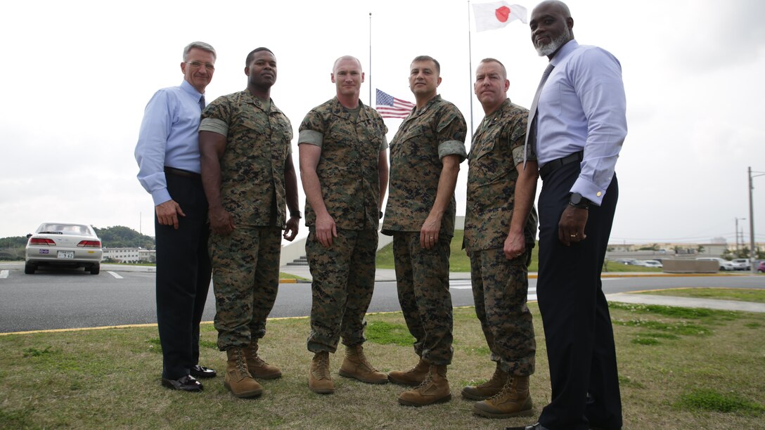 Okinawa based Marines and Department of Defense personnel pose for a photograph March 31 aboard Camp Foster, Okinawa, Japan. The gentlemen were on board a flight leaving Honolulu heading toward Tokyo when an unruly passenger began to threaten fellow passengers. The four Marines and two civilians quickly jumped into action and peacefully apprehended the hostile passenger until he was turned over to Honolulu sheriff’s department. The Okinawa based personnel are with Marine Corps Installations Pacific and III Marine Expeditionary Force.