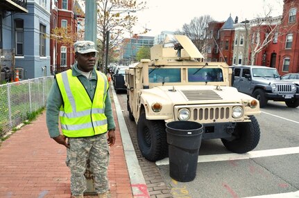 Pvt. 1st Class Ayuk Orock, a culinary specialist with the 547th Transportation Company, District of Columbia Army National Guard, monitors vehicle and pedestrian traffic at a busy intersection in downtown Washington, D.C., in support of the 2016 Nuclear Security Summit held at the Walter E. Washington Convention Center, March 31 and April 1, 2016. 