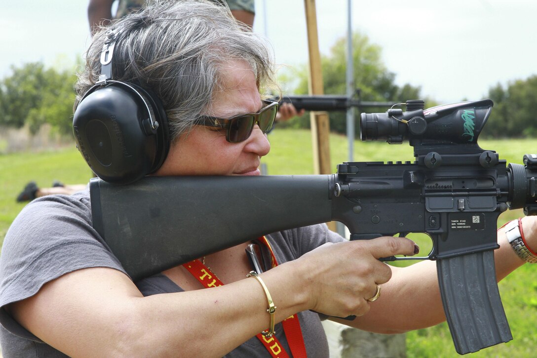 Jeannette Rosado, an educator from New York, looks down the scope of an M-16 rifle during an Educators’ Workshop at Marine Corps Recruit Depot Parris Island, S.C., March 30, 2016. The Marine Corps invited teachers from New York, Maine, Massachusetts, and New Hampshire to see how Marines are made. The educators were given the opportunity to shoot the same weapons as used by recruits and were accompanied by Marine Corps marksman instructors. (U.S. Marine Corps photo by Cpl. Brandon Thomas/released)