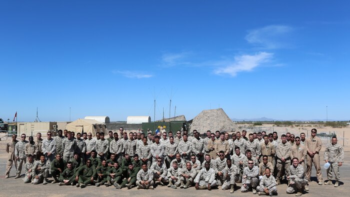 Marines with Marine Unmanned Aerial Vehicle Squadron 1 pose together on the runway built by Marine Wing Support Squadron 371 and MWSS-274 at Cannon Air Defense Complex in Yuma, Arizona, March 25, 2016. In January, VMU-1 Marines began moving from Marine Corps Air-Ground Combat Center Twentynine Palms, California, to the Cannon Air Defense Complex with Marine Aircraft Group 13, where they have access to the aerial support they needed to continue operations.