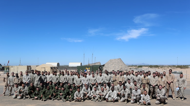 Marines with Marine Unmanned Aerial Vehicle Squadron 1 pose together on the runway built by Marine Wing Support Squadron 371 and MWSS-274 at Cannon Air Defense Complex in Yuma, Arizona, March 25, 2016. In January, VMU-1 Marines began moving from Marine Corps Air-Ground Combat Center Twentynine Palms, California, to the Cannon Air Defense Complex with Marine Aircraft Group 13, where they have access to the aerial support they needed to continue operations.