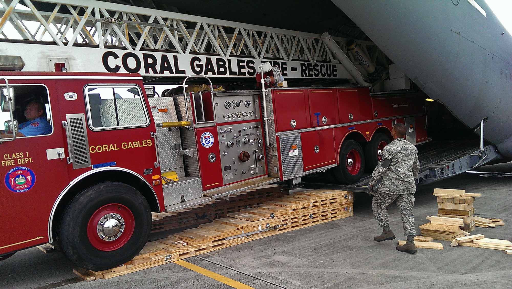 A a City of Coral Gables firetruck is loaded into the back of a Joint Base Charleston C-17 Globemaster III at Homestead Air Reserve Base, Fl.  A Reserve aircrew from the 300th Airlift Squadron took the donated fire truck to to La Antigua, Guatemala. (Courtesy Photo)