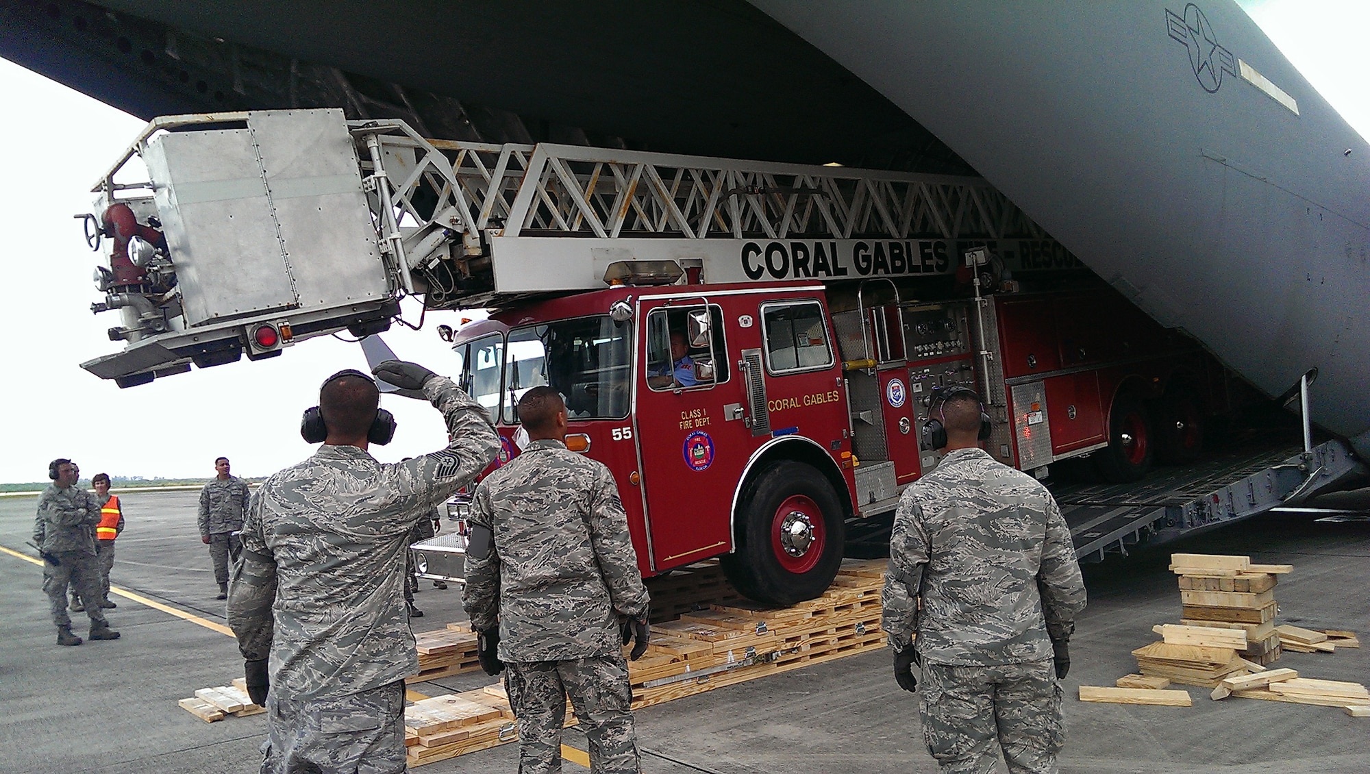 A a City of Coral Gables firetruck is loaded into the back of a Joint Base Charleston C-17 Globemaster III at Homestead Air Reserve Base, Fl. April 2.  Reservists from 300th Airlift Squadron delivered the donated fire truck to to La Antigua, Guatemala as part of the Denton Cargo program. (Courtesy Photo)