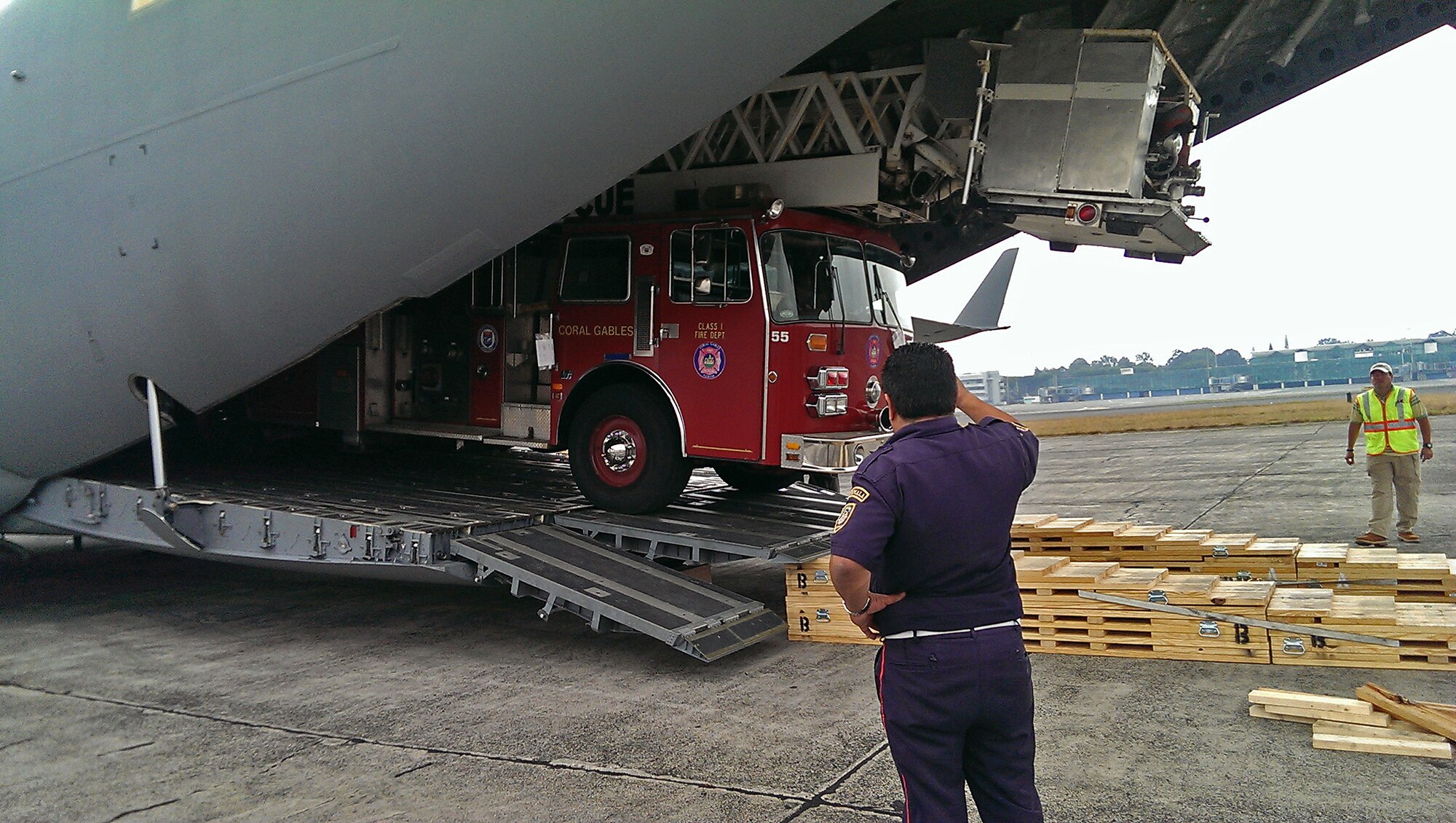 A a City of Coral Gables firetruck is unloaded from the back of a Joint Base Charleston C-17 Globemaster III La Antigua, Guatemala April 2.  Reservists from 300th Airlift Squadron delivered the donated fire truck as part of the Denton Cargo program. (Courtesy Photo)
