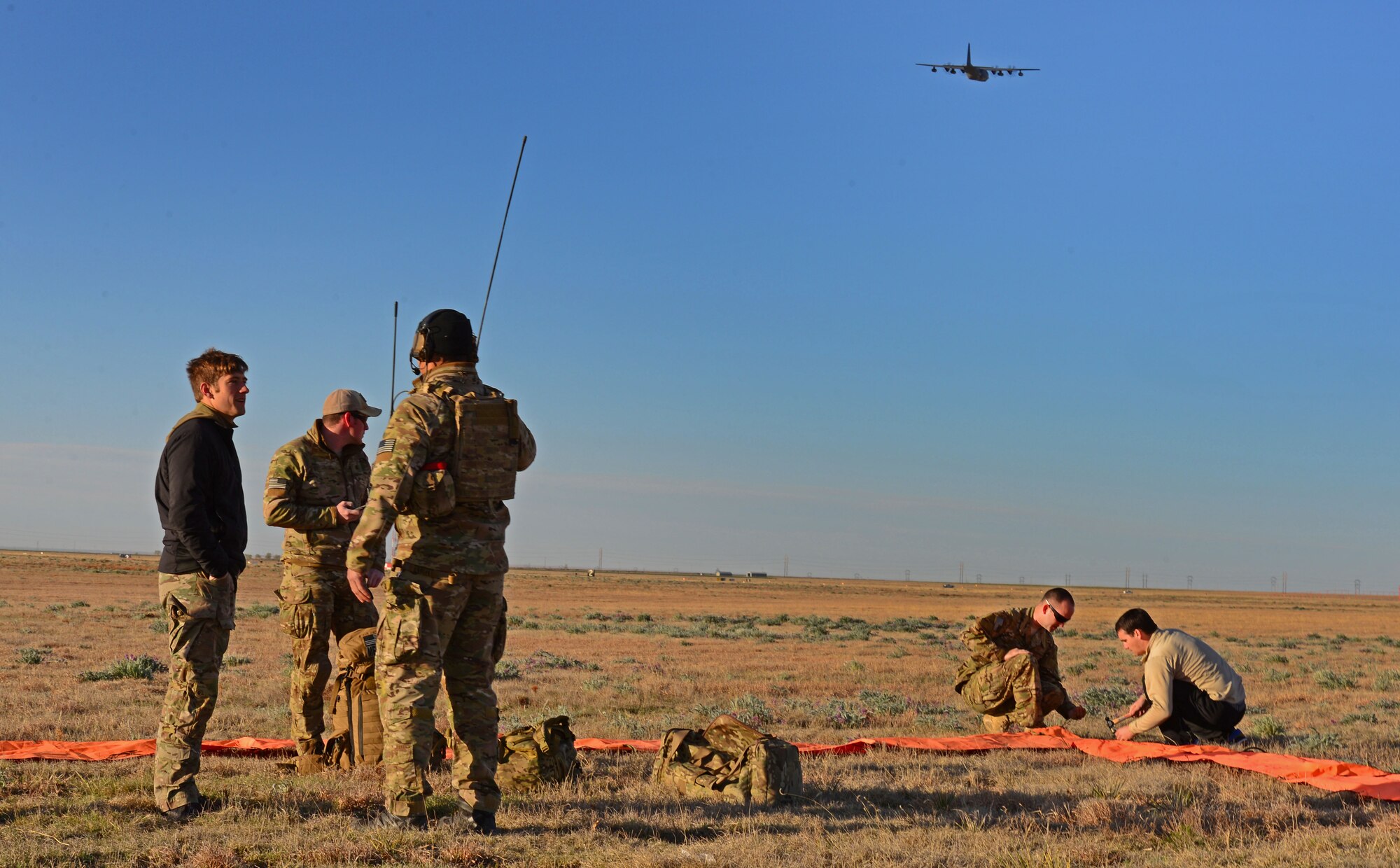 A ground team crew with the 26th Special Tactics Squadron prepares a landing zone March 25, 2016, at Cannon Air Force Base, N.M. Ground members established a safe area for other 26th STS members who would be performing routine practice jumps over the Cannon flightline shortly after the area was secure. (U.S. Air Force photo/Staff Sgt. Alexx Pons) 