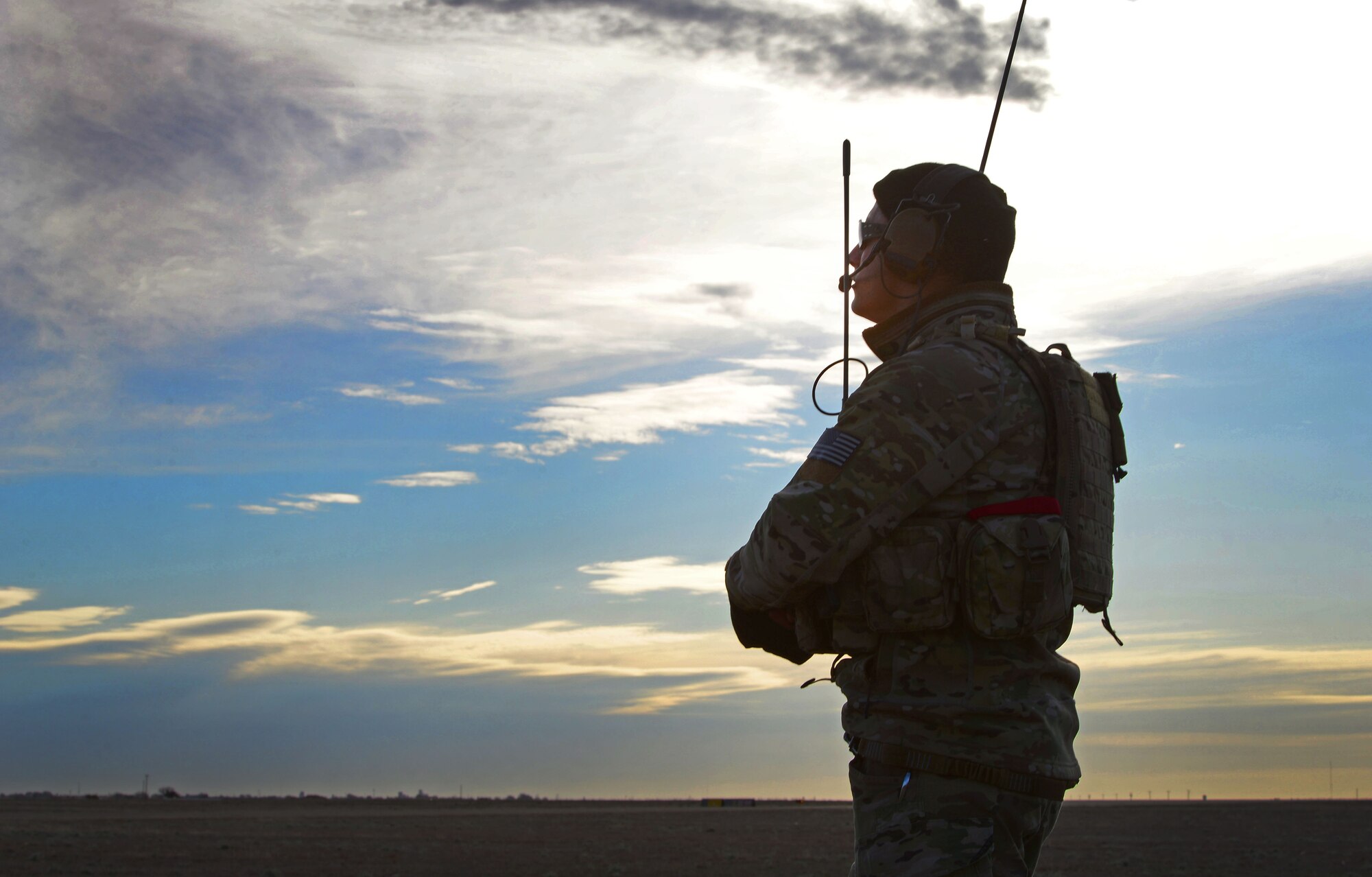 A member of the 26th Special Tactics Squadron monitors weather patterns and maintains communication with Air Commandos flying overhead March 25, 2016, at Cannon Air Force Base, N.M. Dozens of 26th STS members performed routine practice jumps over the Cannon flightline, and relied on ground crews to ensure exercise safety and success. (U.S. Air Force photo/Staff Sgt. Alexx Pons) 