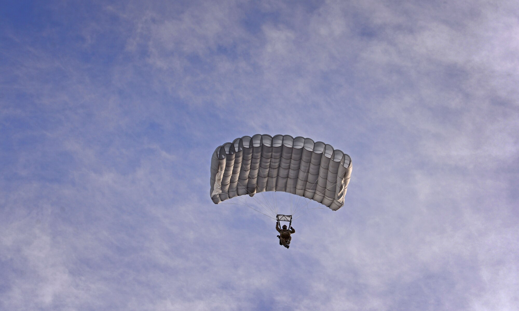 A member of the 26th Special Tactics Squadron parachutes down over the flightline March 25, 2016, at Cannon Air Force Base, N.M. Air Commandos with the 26th STS performed routine practice jumps as part of maintaining operational readiness. (U.S. Air Force photo/Staff Sgt. Alexx Pons) 